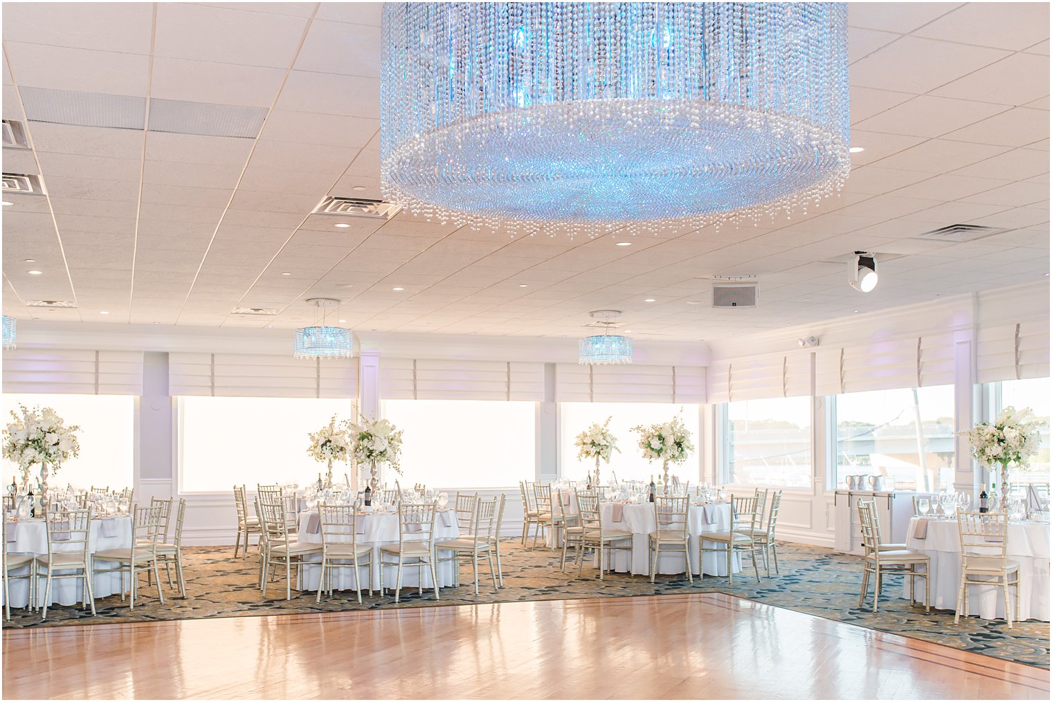 Crystal Point Yacht Club wedding reception with dance floor and blue chandelier