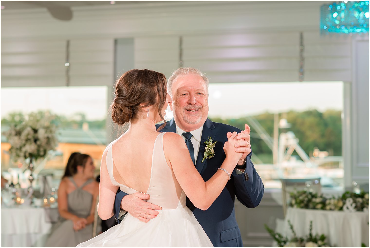 bride dances with father at Crystal Point Yacht Club