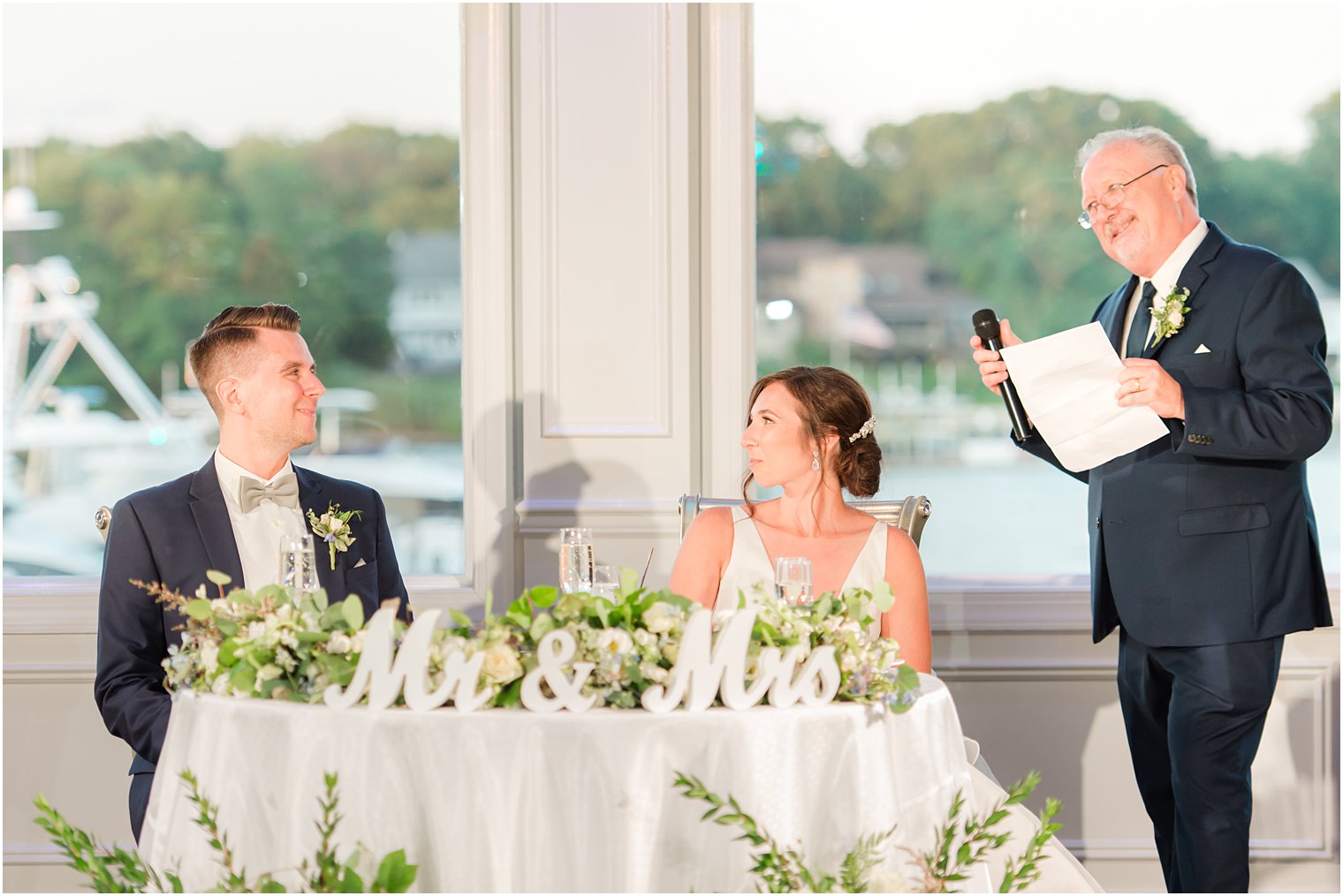 father reads speech during reception 