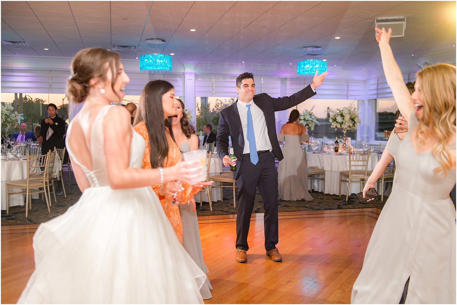 guests dance with bride during wedding reception at Crystal Point Yacht Club