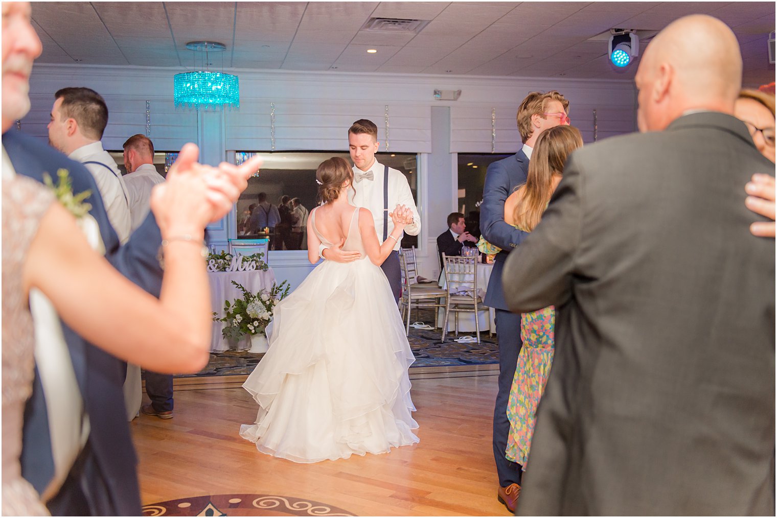 bride and groom dance together in ballroom at Crystal Point Yacht Club