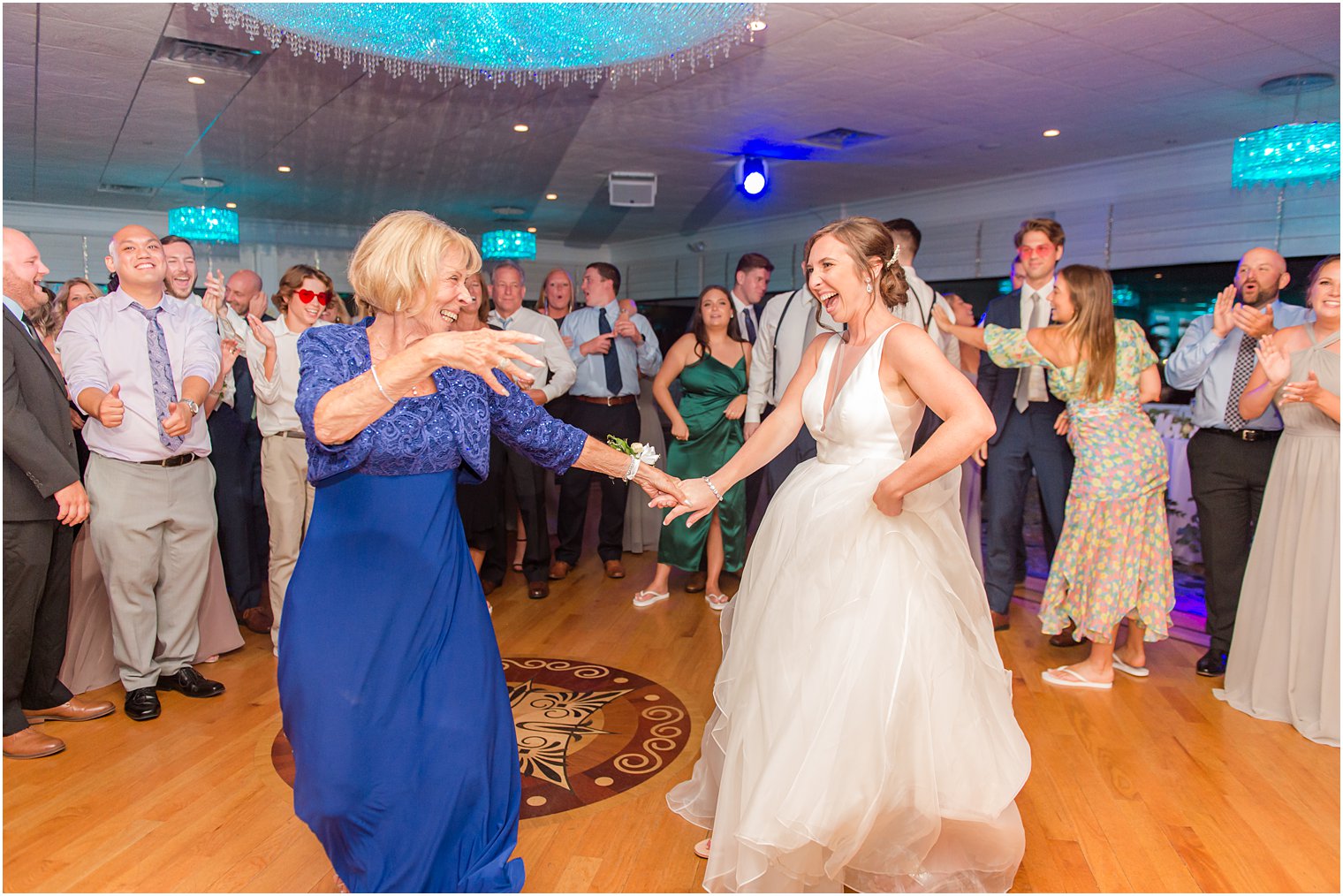 bride dances with grandmother on dance floor 