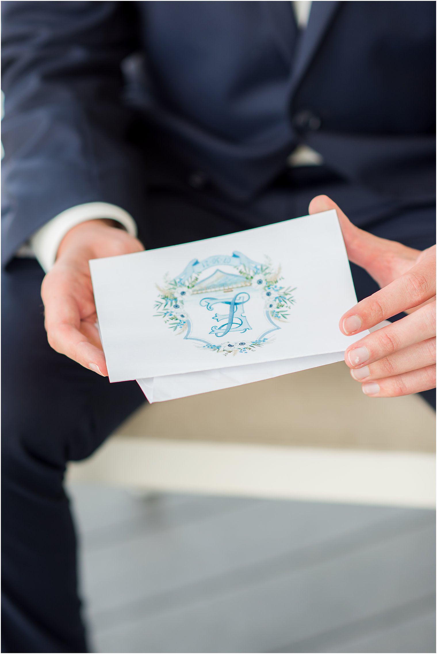 groom holds letter from bride with custom seal