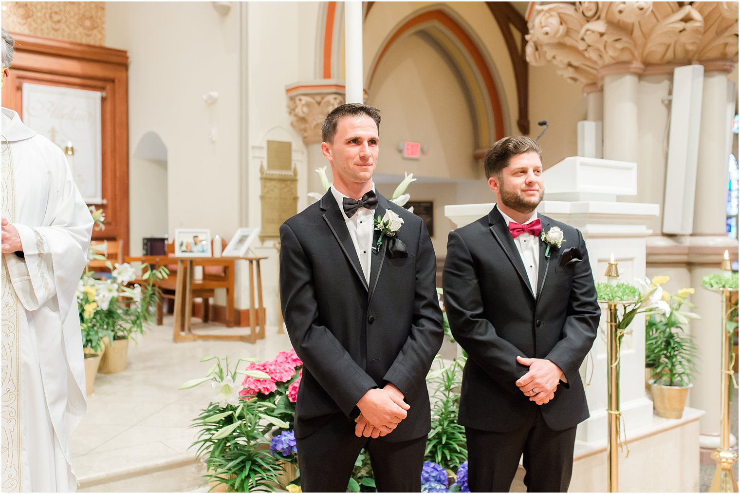 groom stands at alter waiting for bride in St. Vincent's Martyr Catholic Church