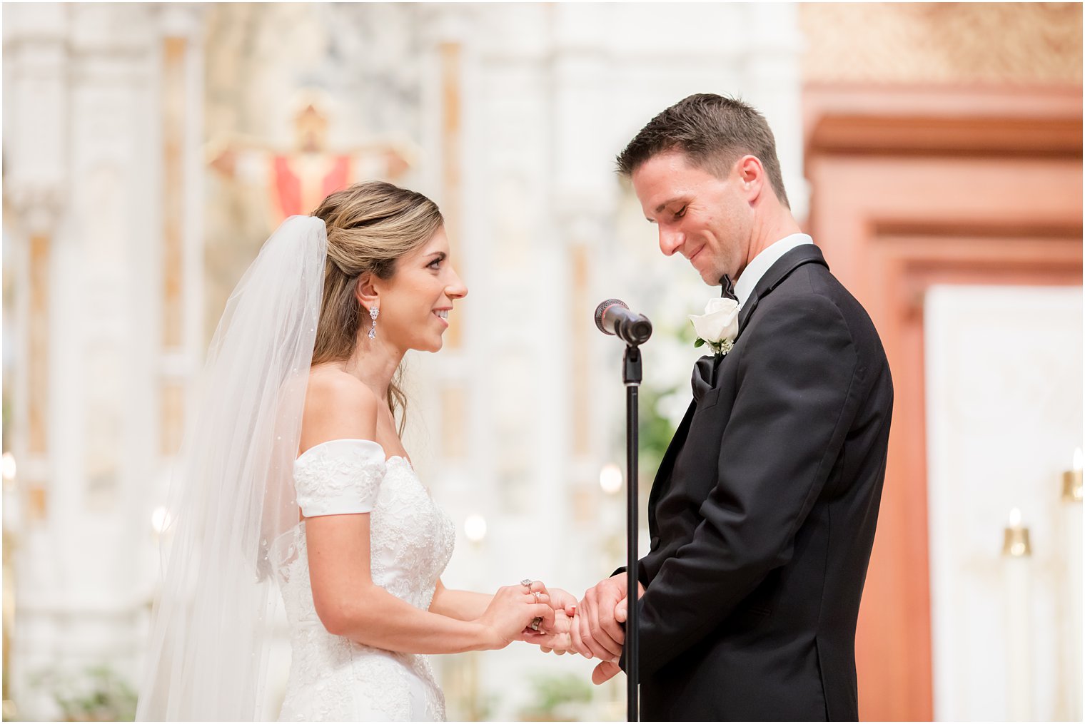 newlyweds exchange vows during wedding ceremony at St. Vincent's Martyr Catholic Church
