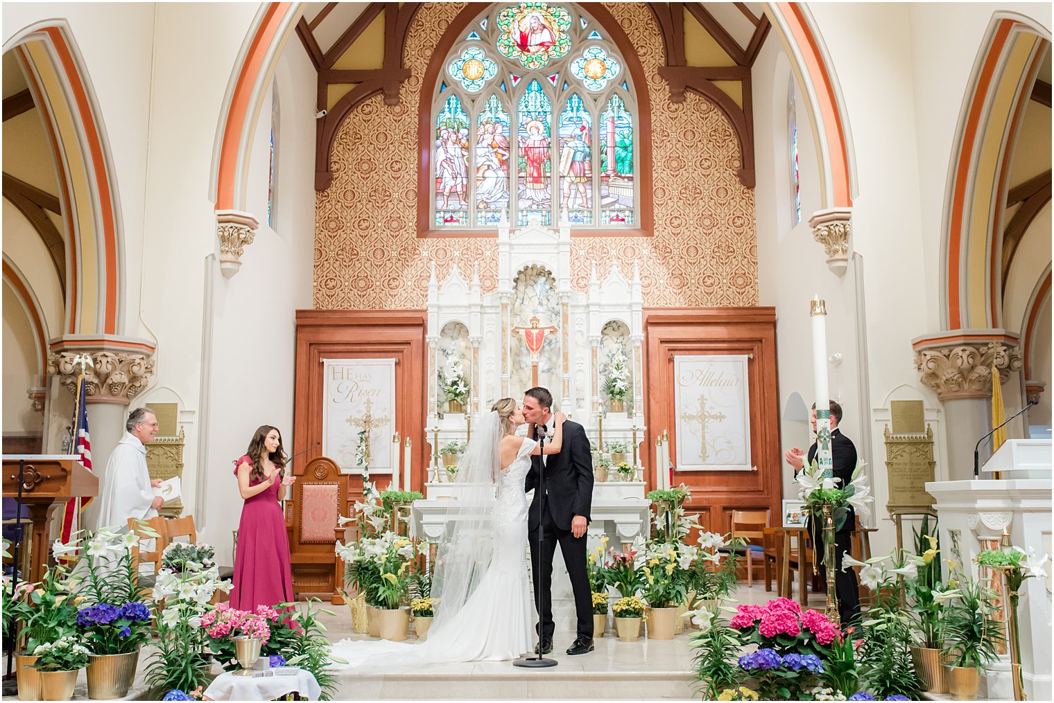 bride and groom kiss during ceremony at St. Vincent's Martyr Catholic Church