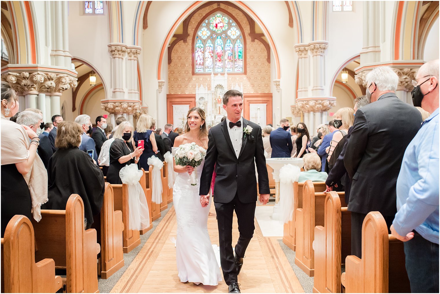 bride and groom walk up aisle at St. Vincent's Martyr Catholic Church