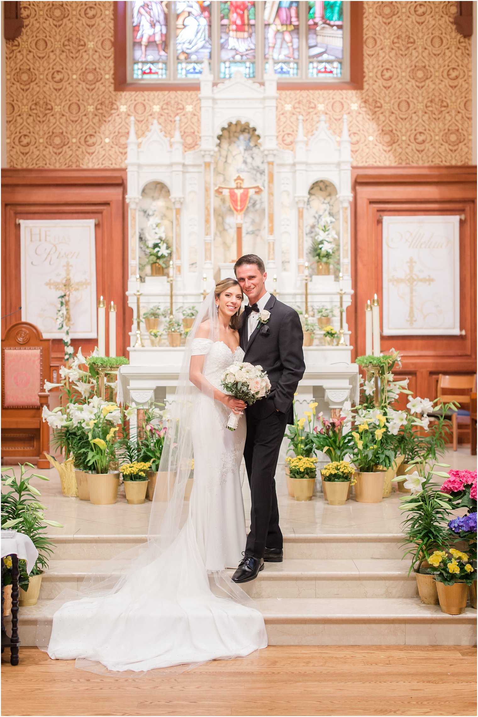 bride and groom stand on alter at St. Vincent's Martyr Catholic Church