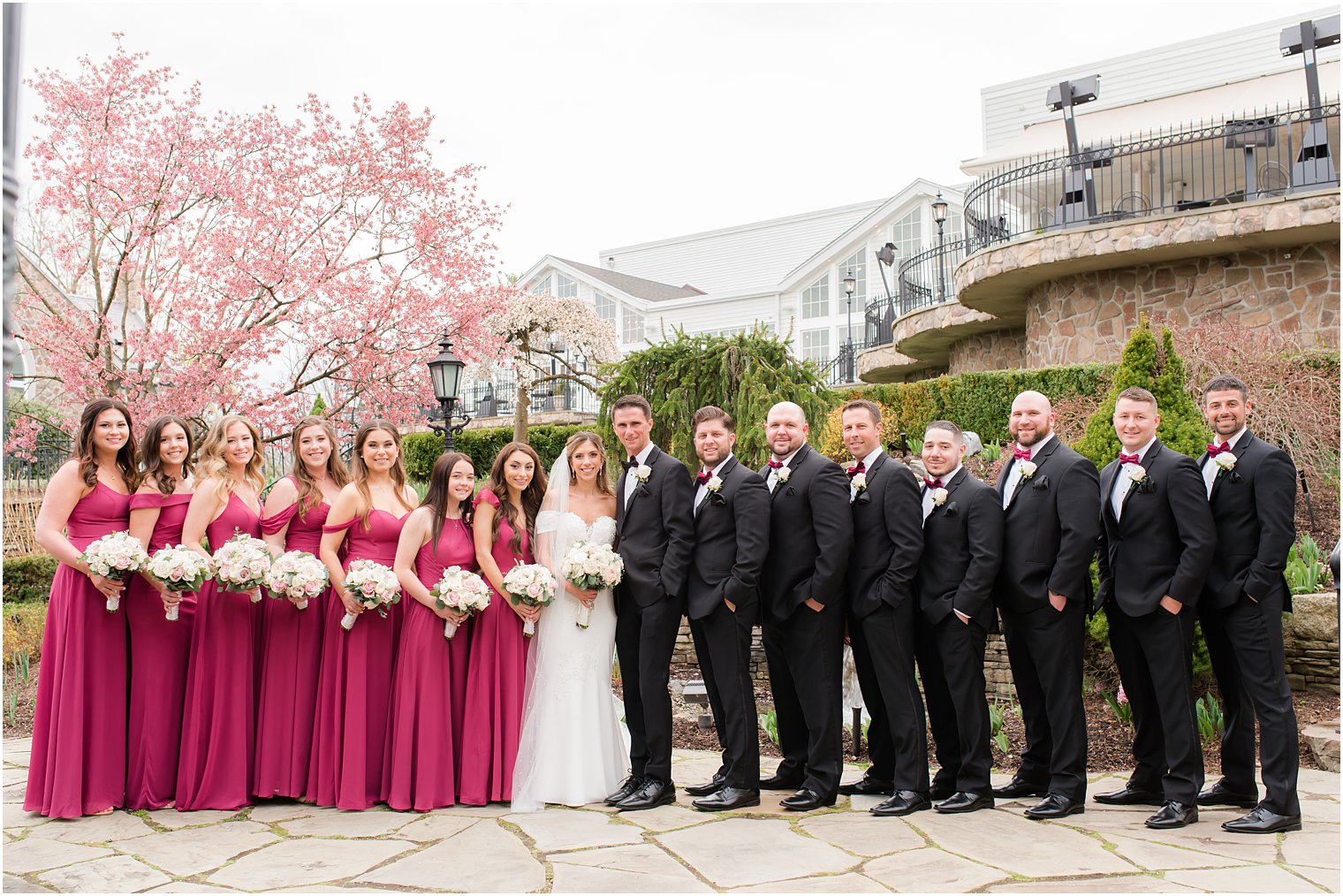 bride and groom pose with wedding party in pink and black at Park Savoy Estate