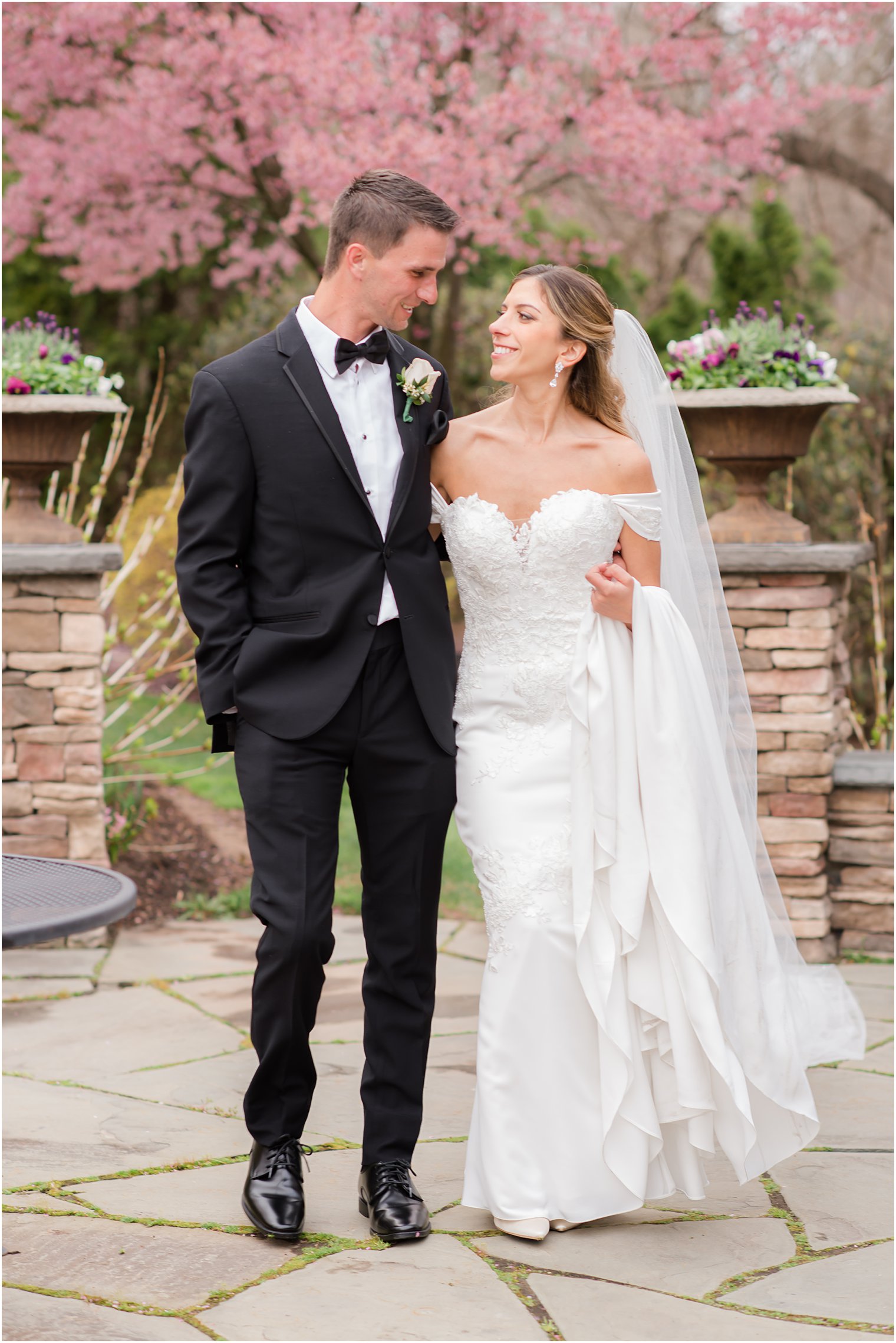 bride and groom walk through stone patio at Park Savoy Estate