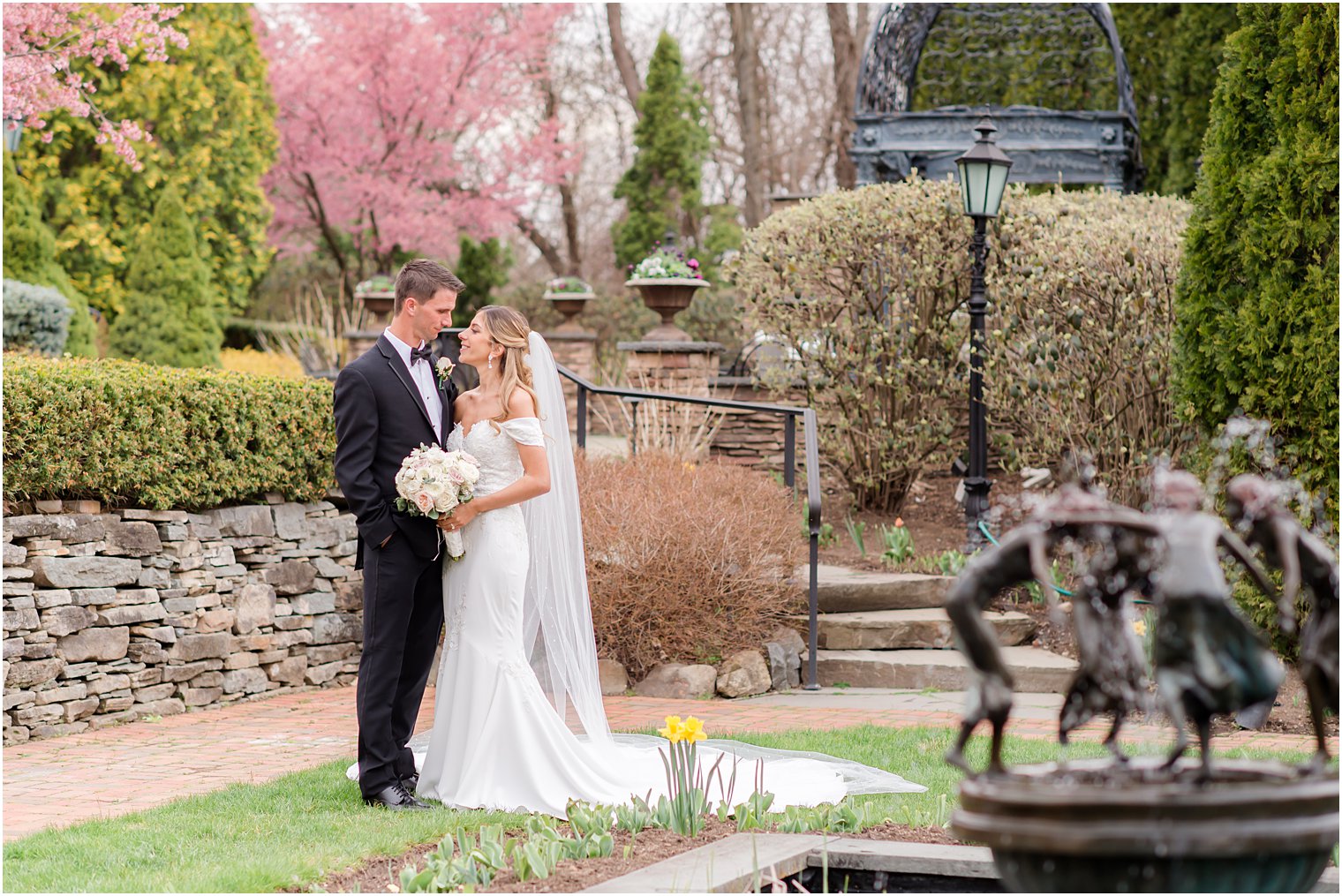 bride looks at groom standing in garden at Park Savoy Estate
