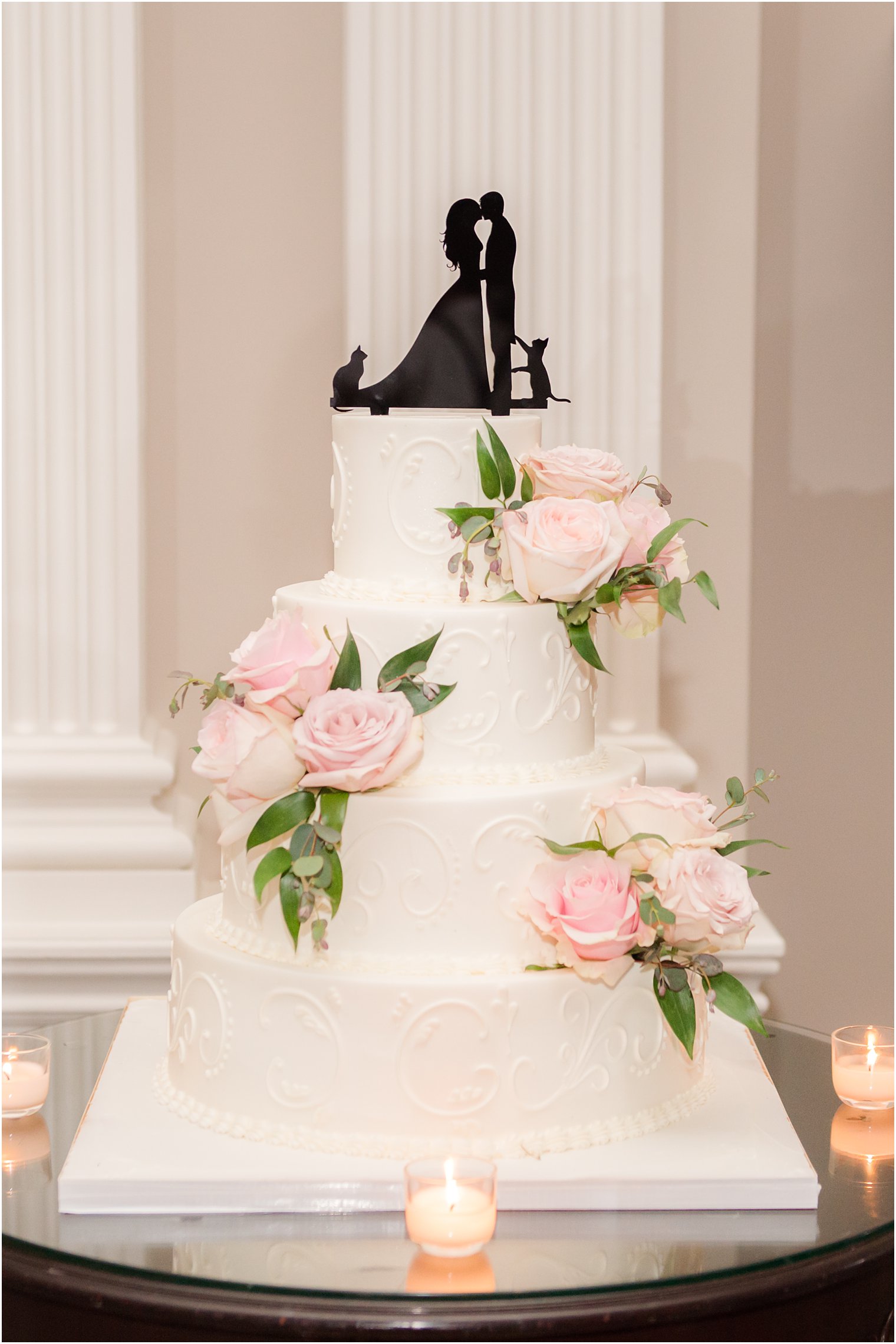 tiered wedding cake with pink rose details 