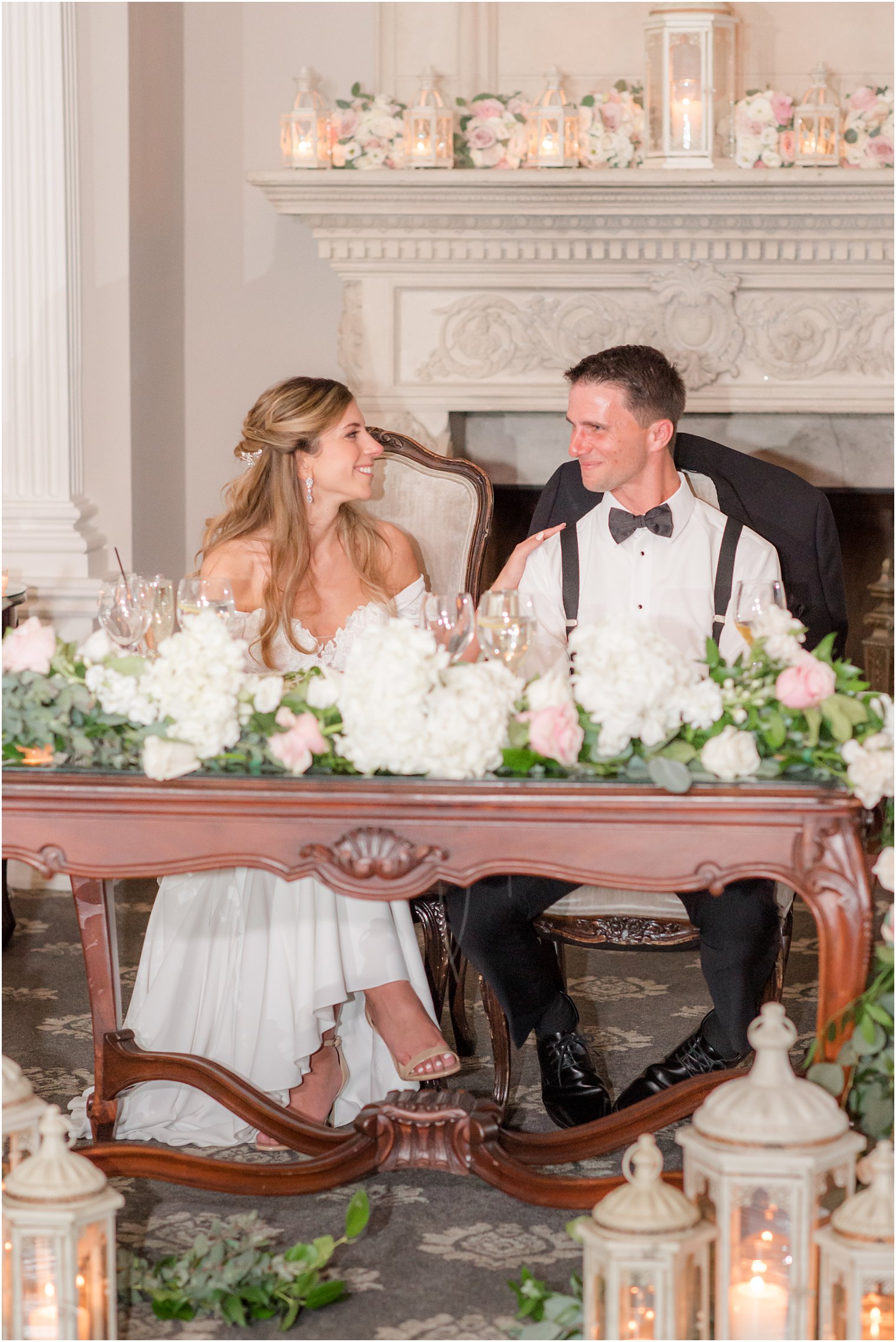 bride and groom sit at sweetheart table talking at Park Savoy Estate
