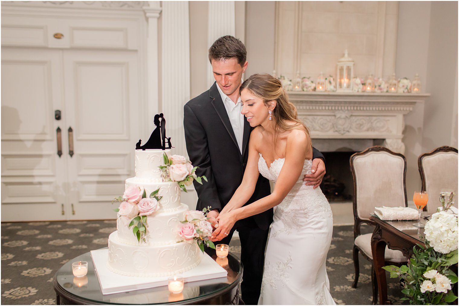 bride and groom cut wedding cake in ballroom at Park Savoy Estate