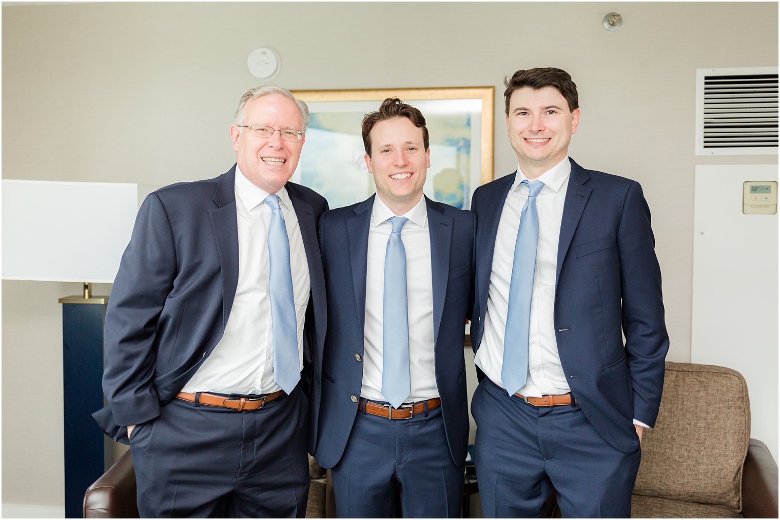 groom poses with father and brother 