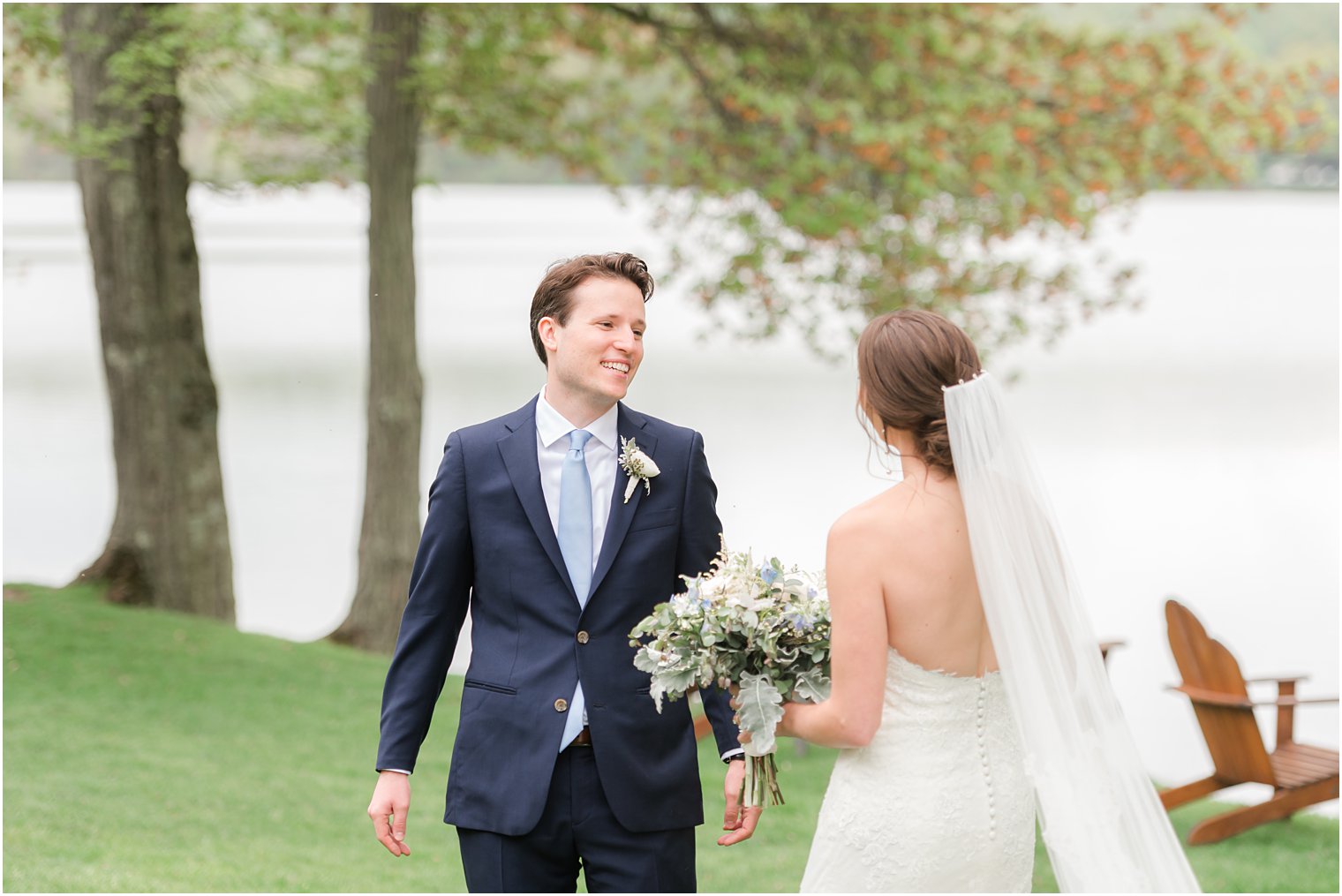 groom smiles turning to see bride during first look at Indian Trail Club