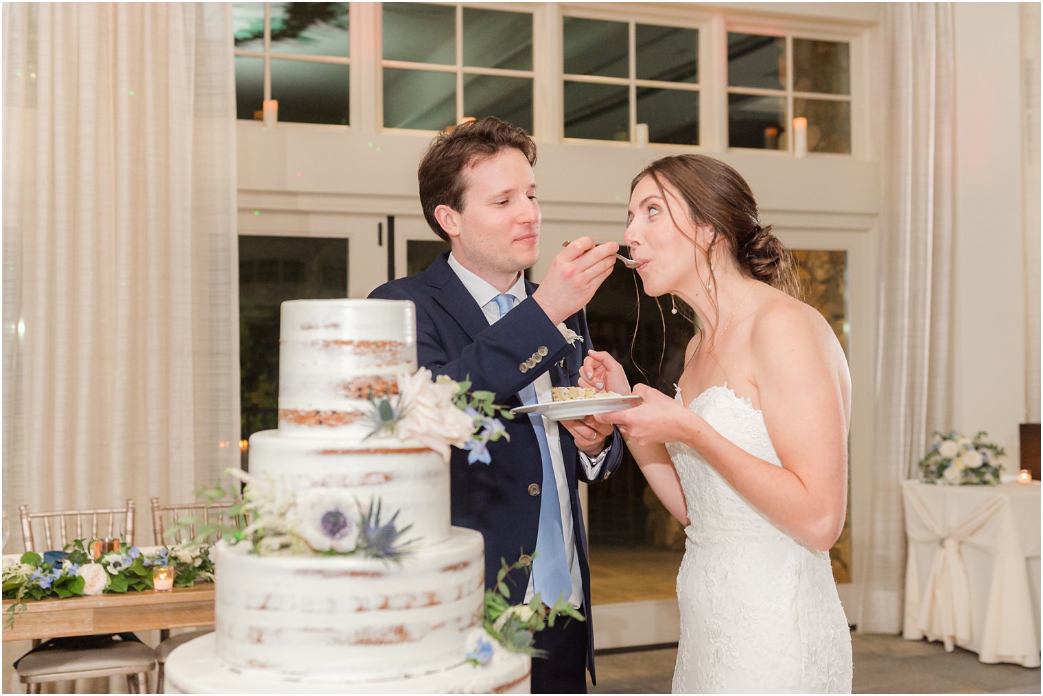 bride and groom cut naked wedding cake during spring wedding reception
