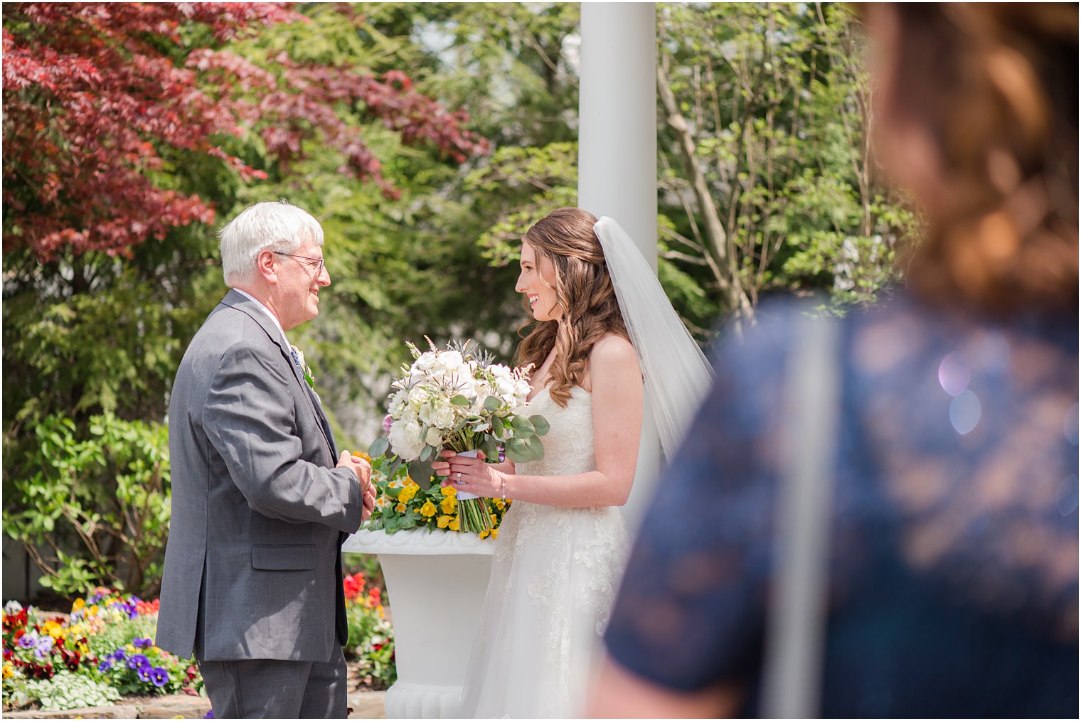 mother watches bride have first look before English Manor wedding with dad 
