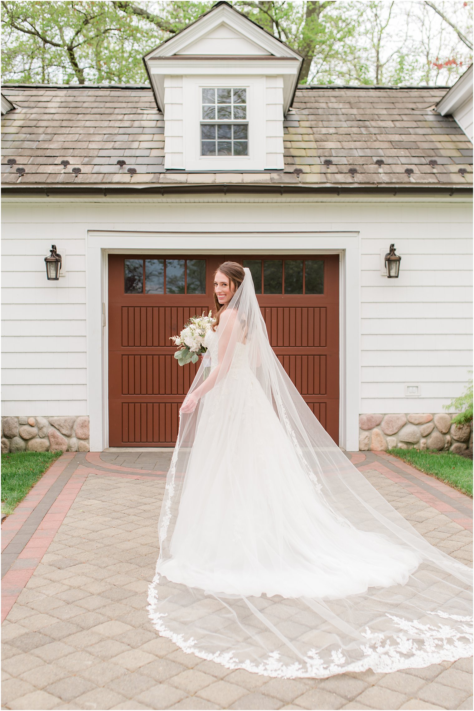 bride looks over shoulder at back of wedding gown 