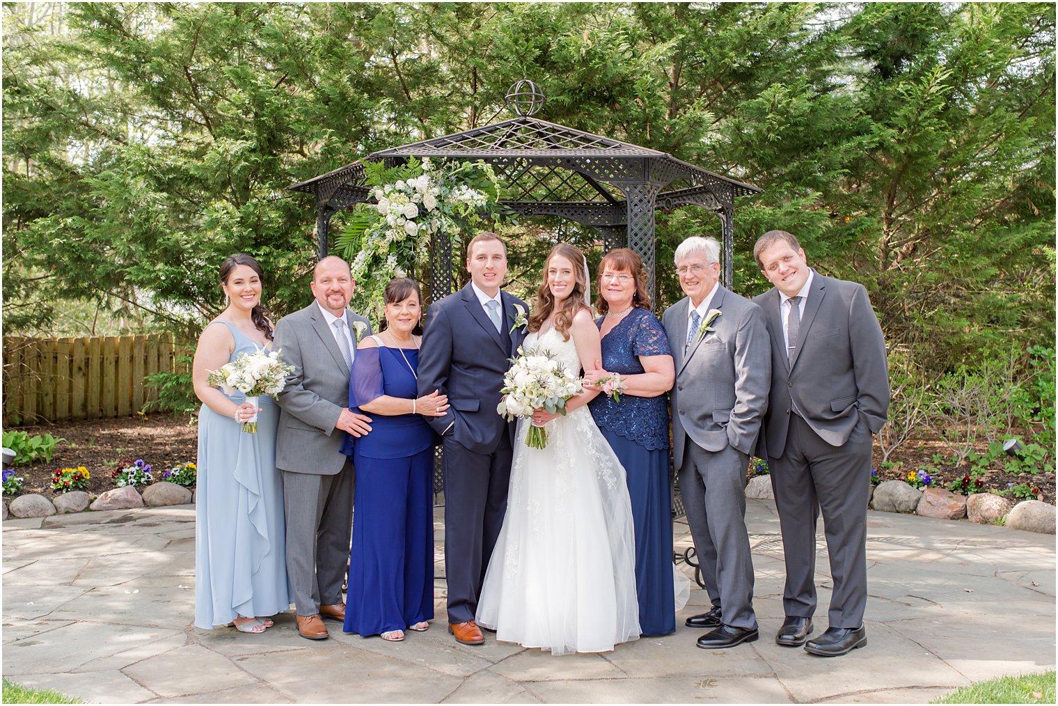 bride and groom stand with family at The English Manor