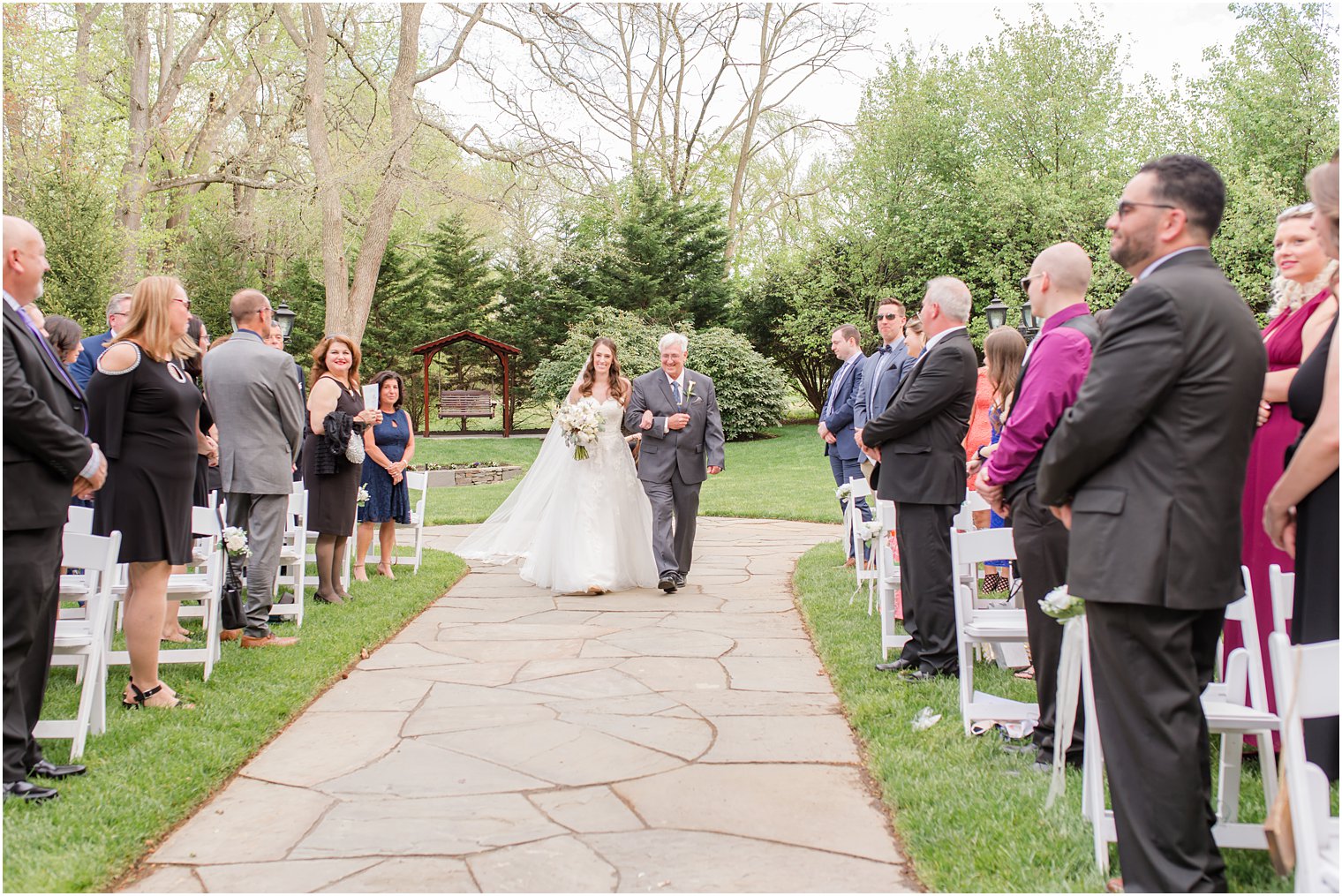 bride and father walk into garden wedding ceremony in New Jersey