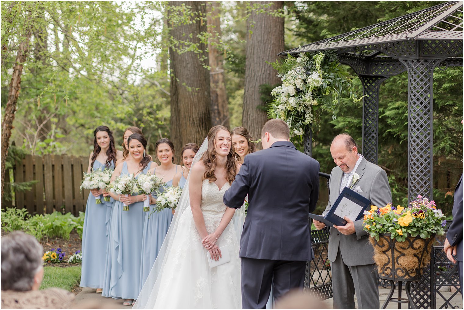 bride laughs during garden wedding ceremony 