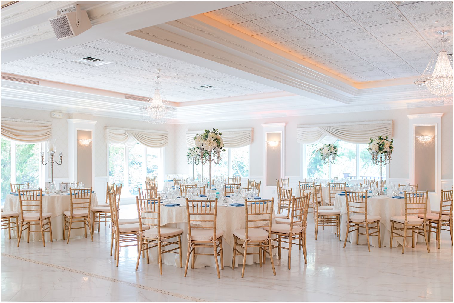 ballroom wedding reception with white floral centerpieces 