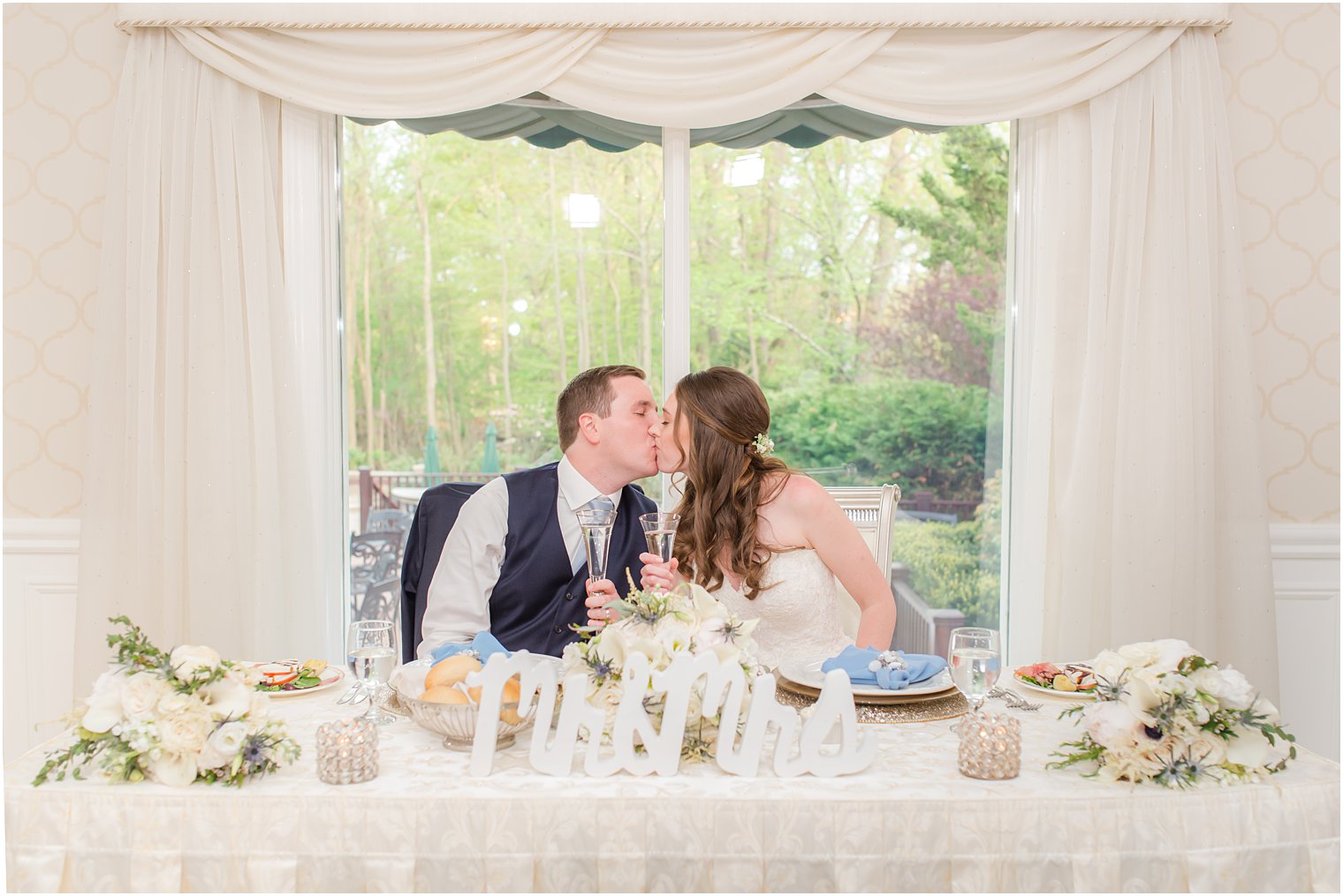 newlyweds kiss at sweetheart table in New Jersey 
