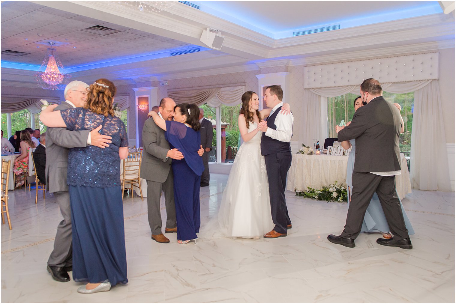bride and groom dance during NJ wedding reception with parents 