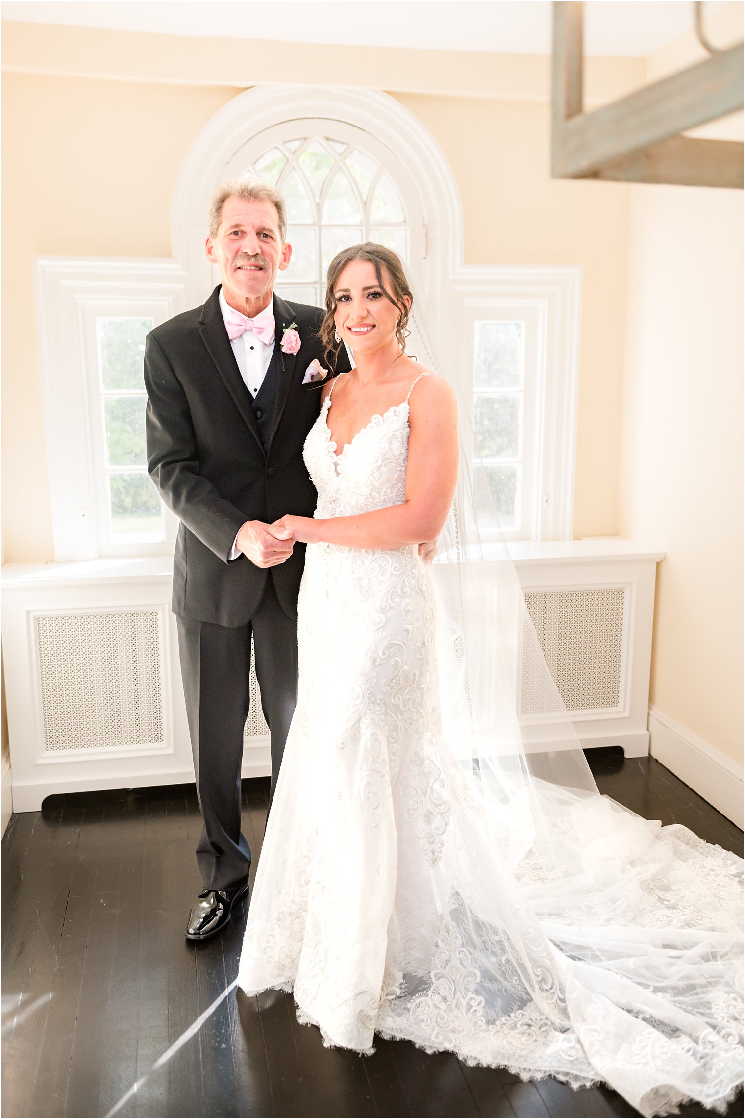 bride stands with father in bridal suite at The Inn at Fernbrook Farms