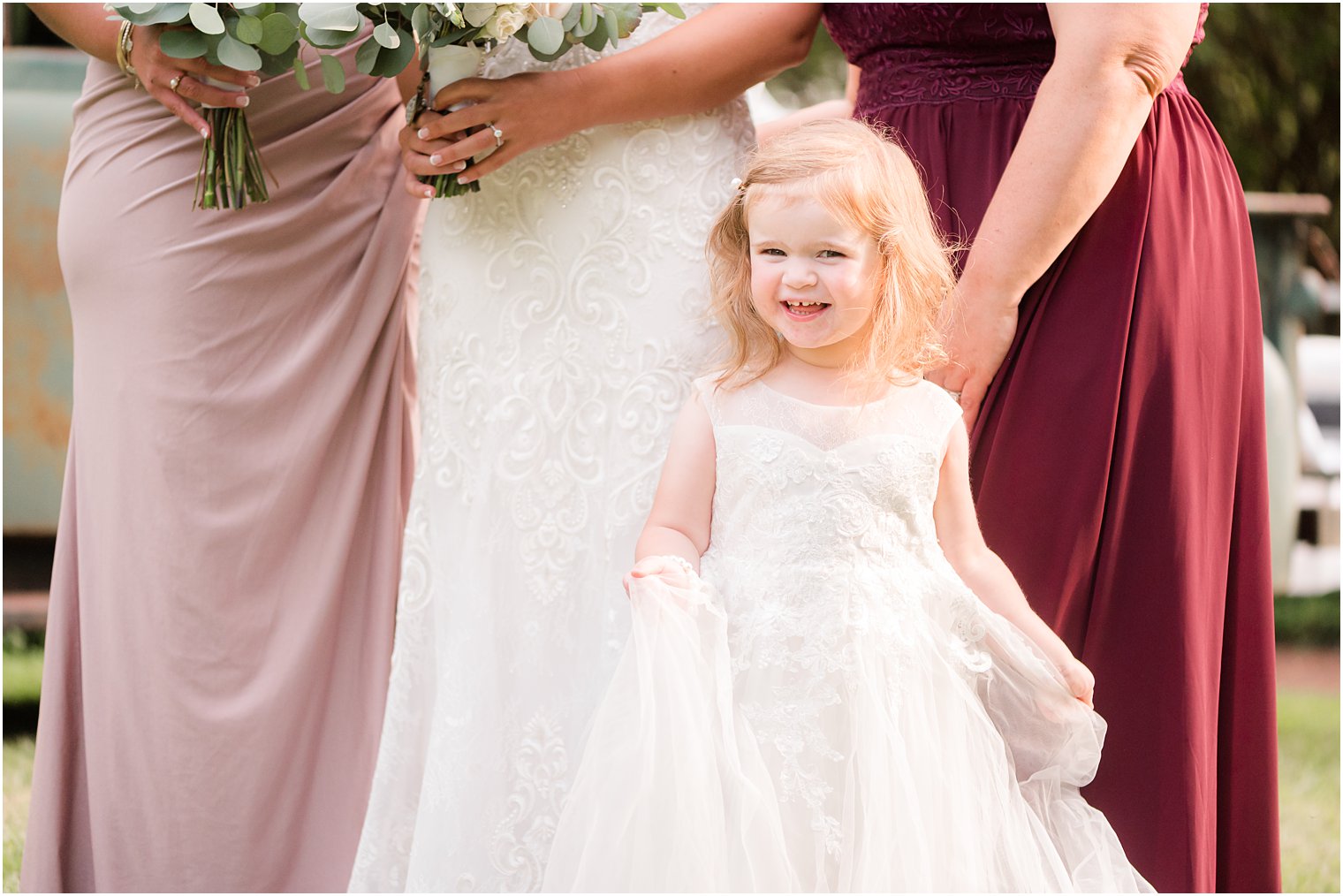 flower girls smiles standing by bride and bridesmaids
