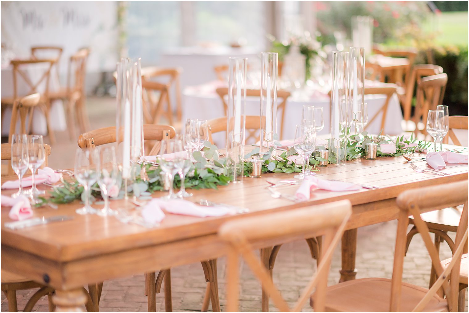 wooden table with tall candles in center at The Inn at Fernbrook Farms