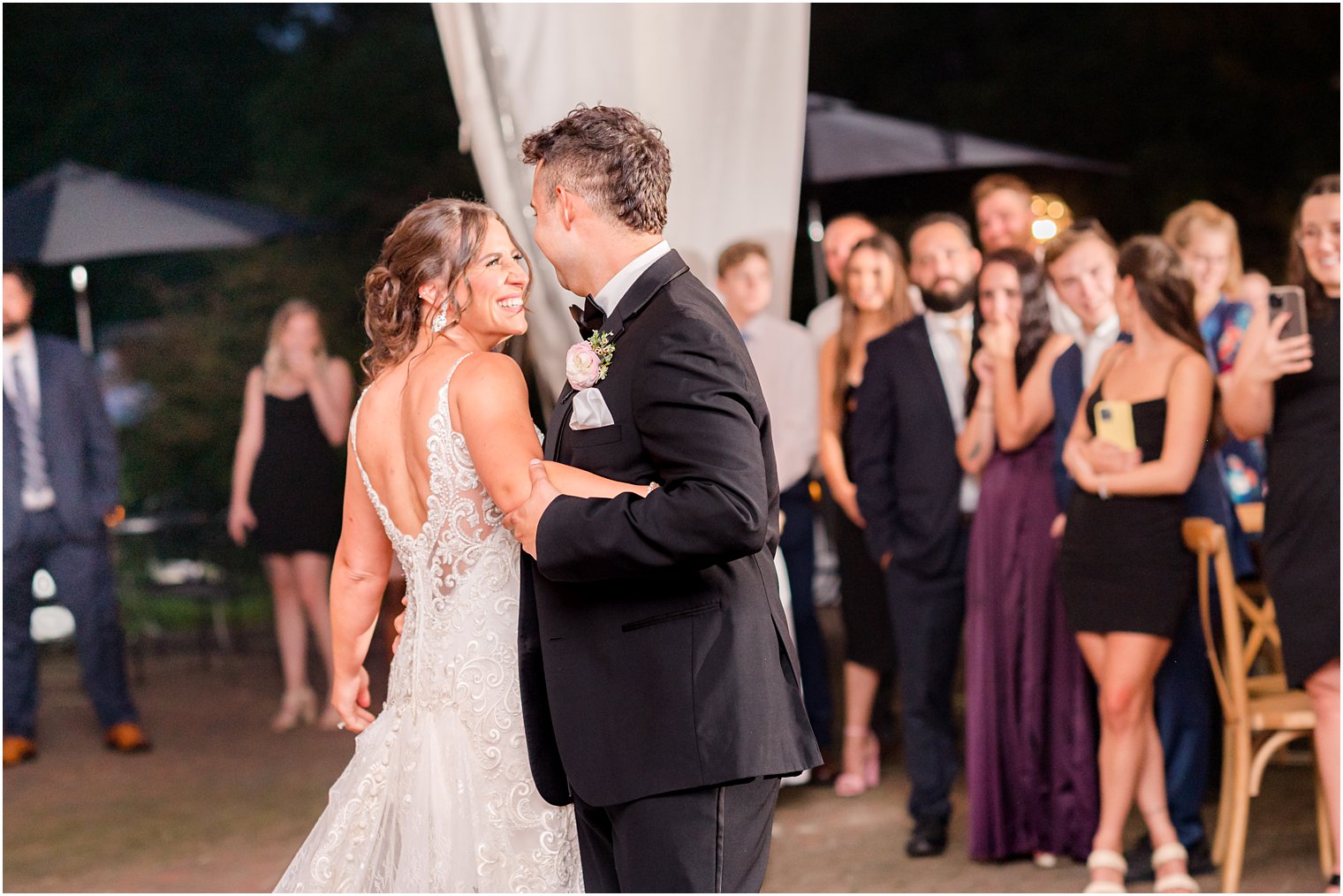 groom twirls bride around during wedding reception 