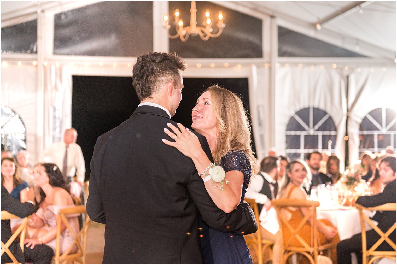 mother looks up at groom during wedding reception 