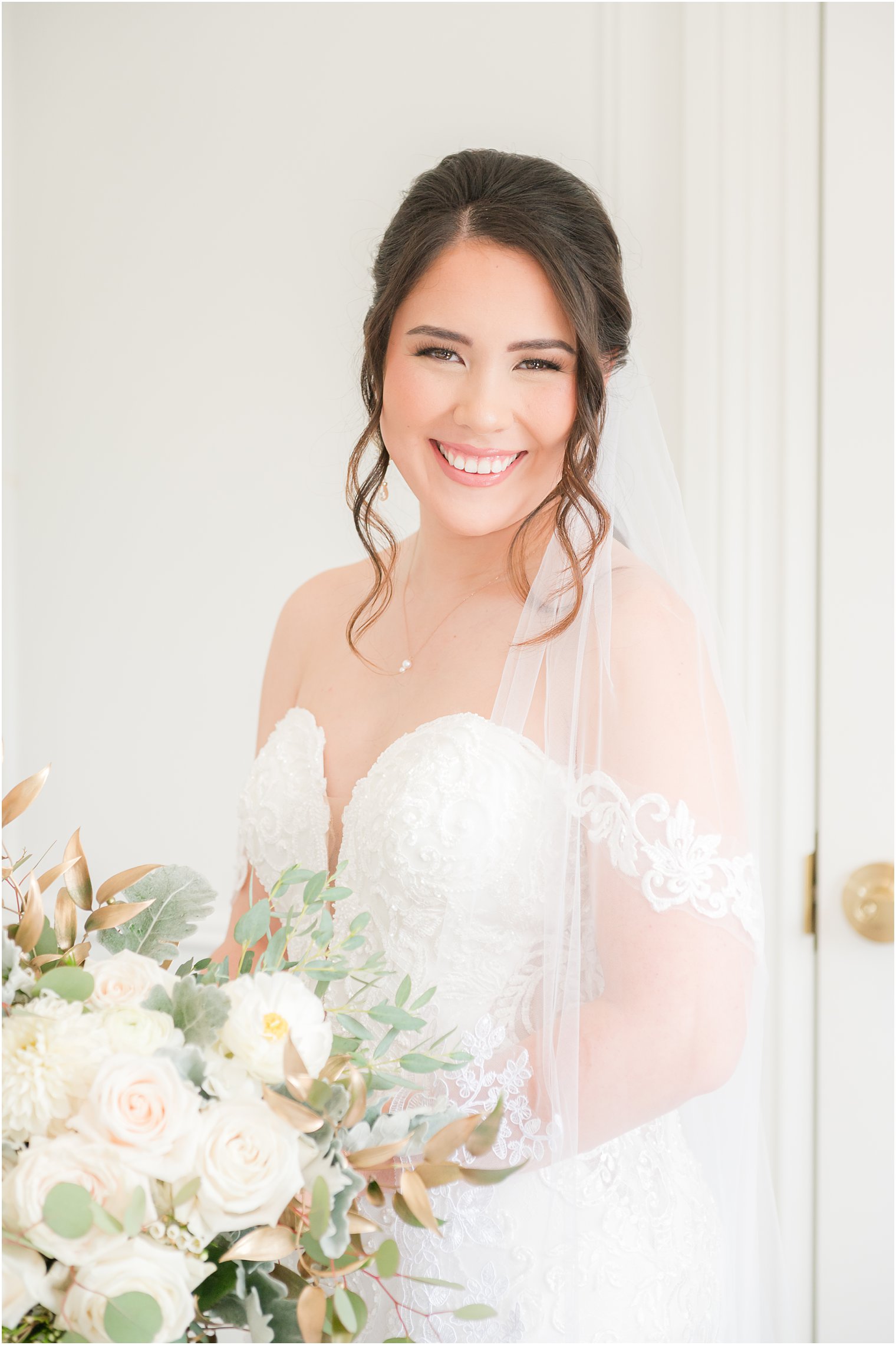 bride smiles with veil around shoulders before wedding at Park Chateau Estate