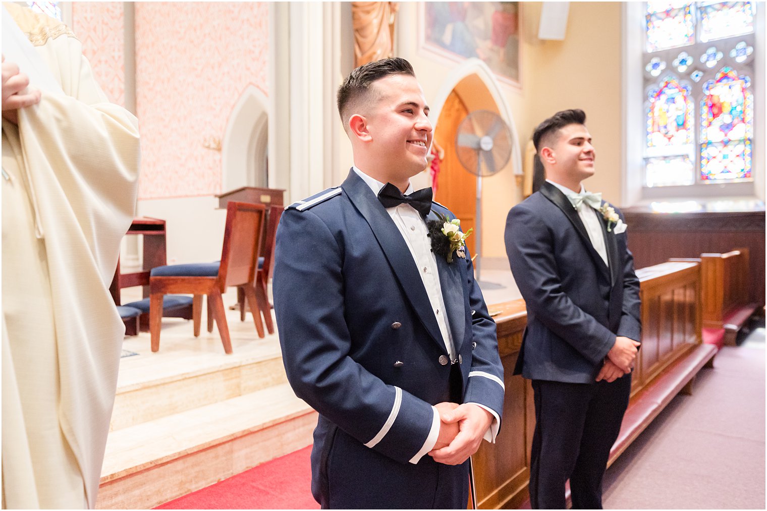 groom in military uniform watches bride enter wedding ceremony at St. Peter's Catholic Church