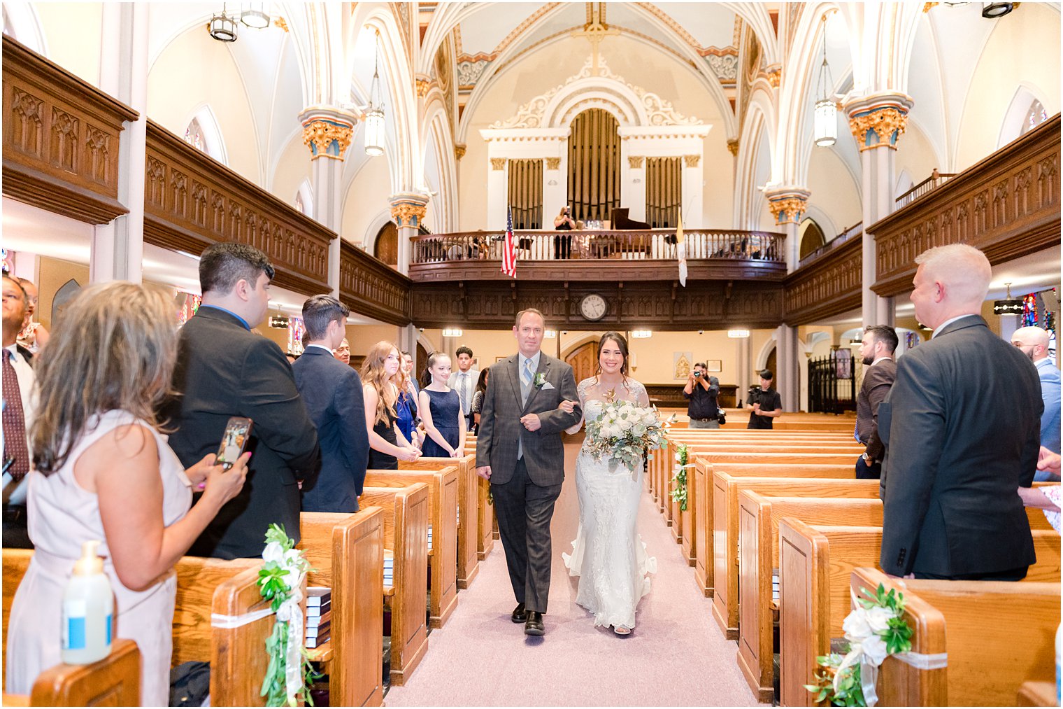 father walks bride down aisle at wedding ceremony at St. Peter's Catholic Church
