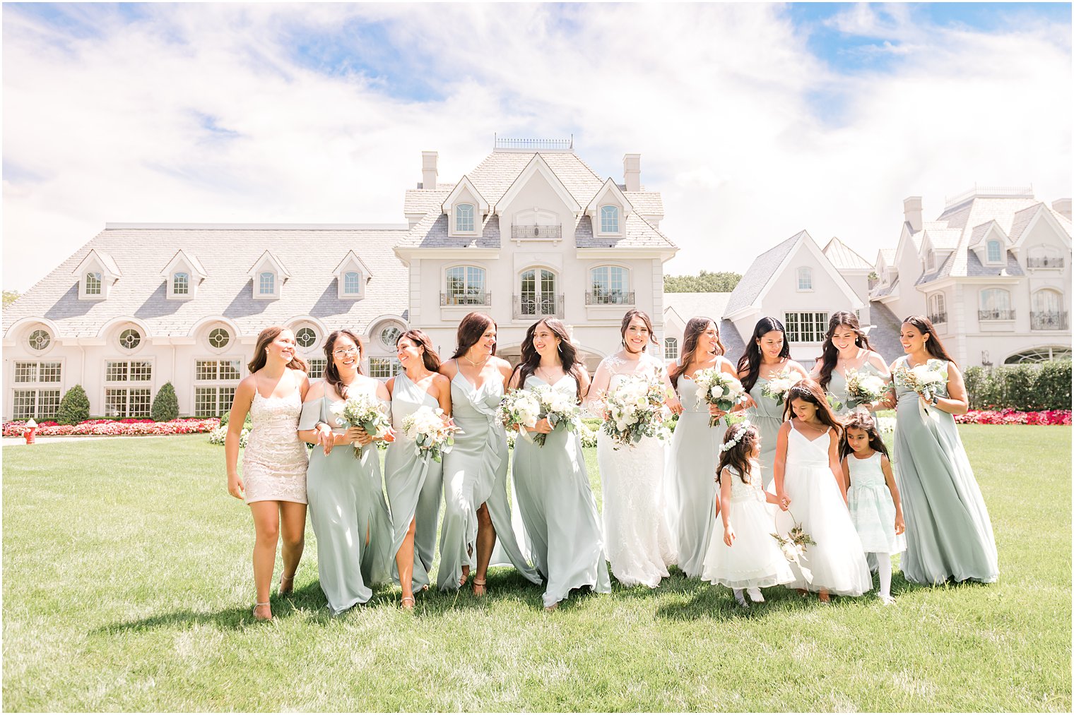 bride walks with bridesmaids in front of Park Chateau Estate