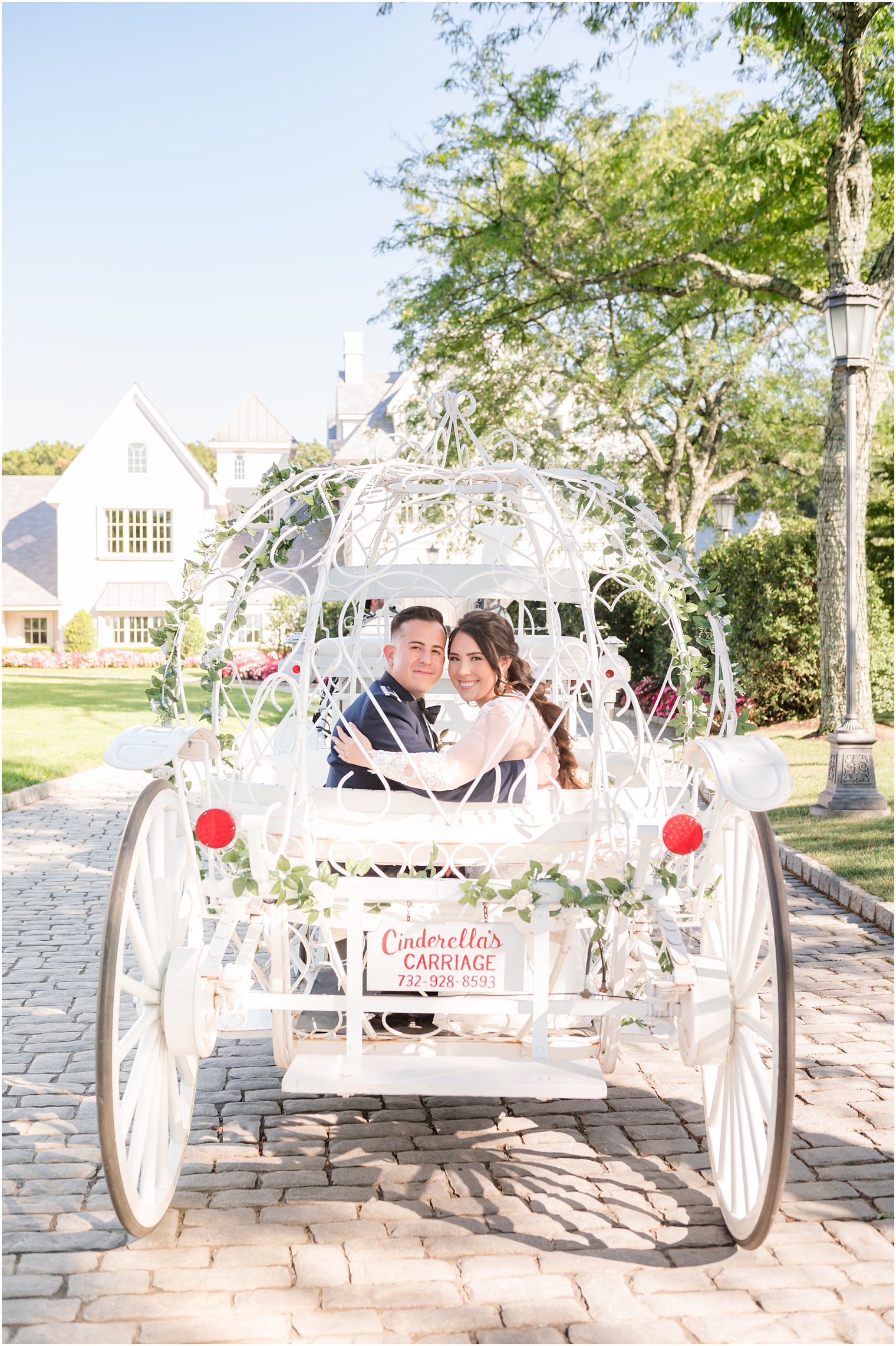 newlyweds hug in back of cinderella carriage outside Park Chateau Estate