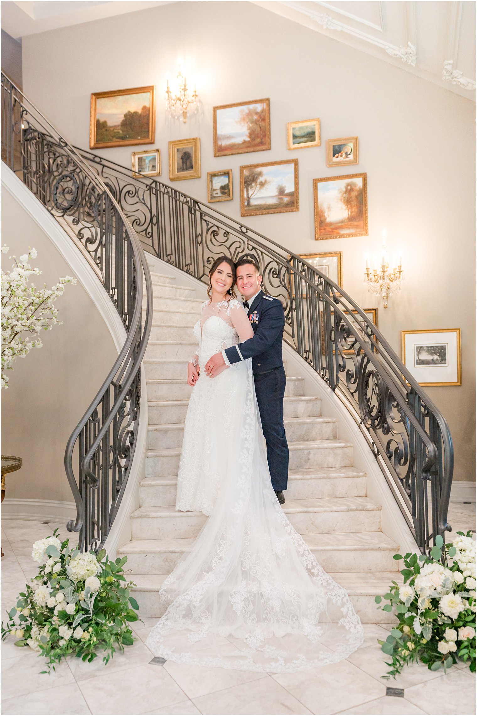 newlyweds stand hugging on staircase inside Park Chateau Estate