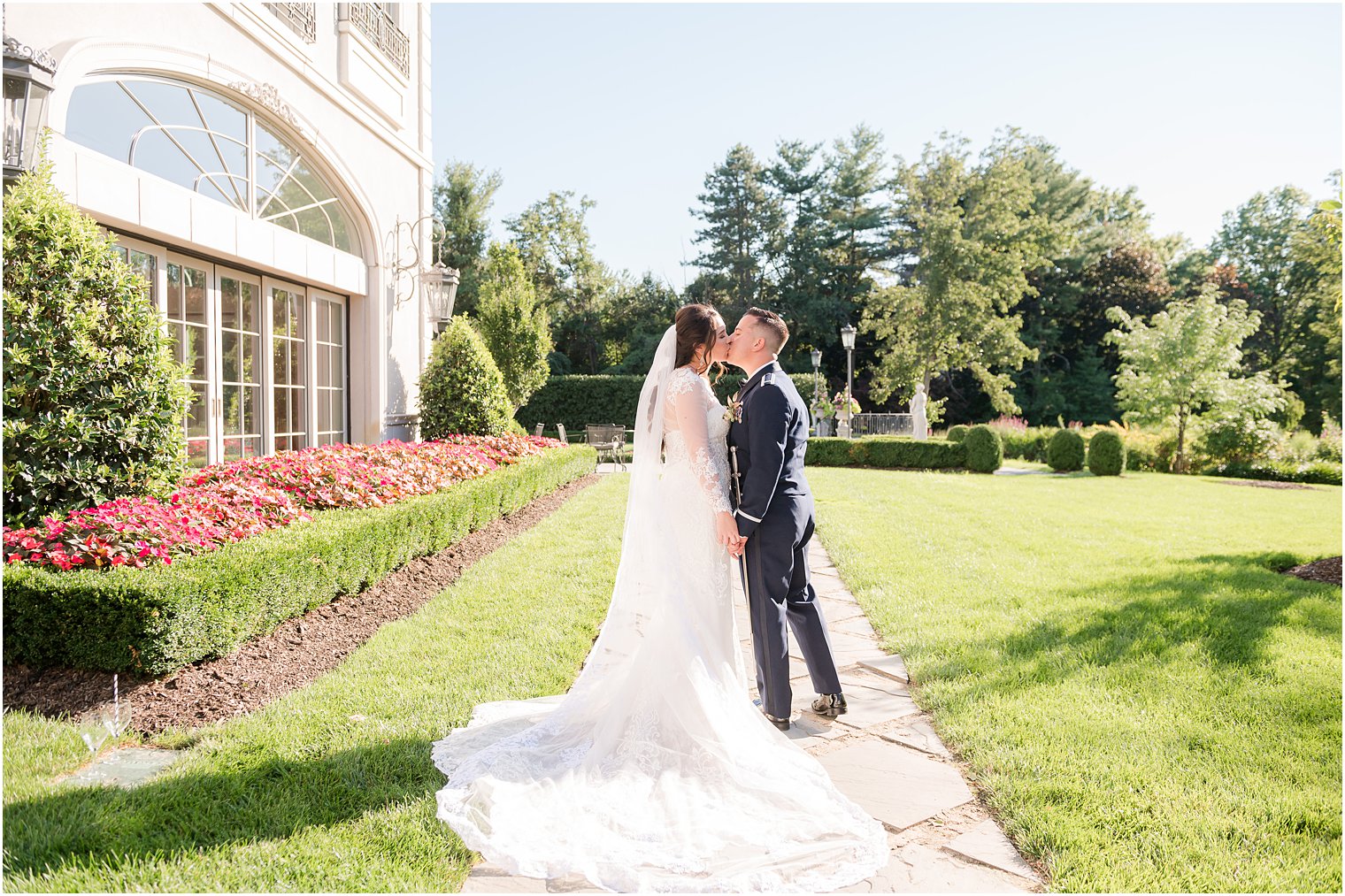 groom kisses bride's cheek on walkway at Park Chateau Estate