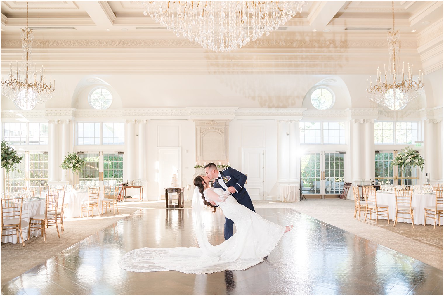groom dips bride during dance in ballroom at Park Chateau Estate