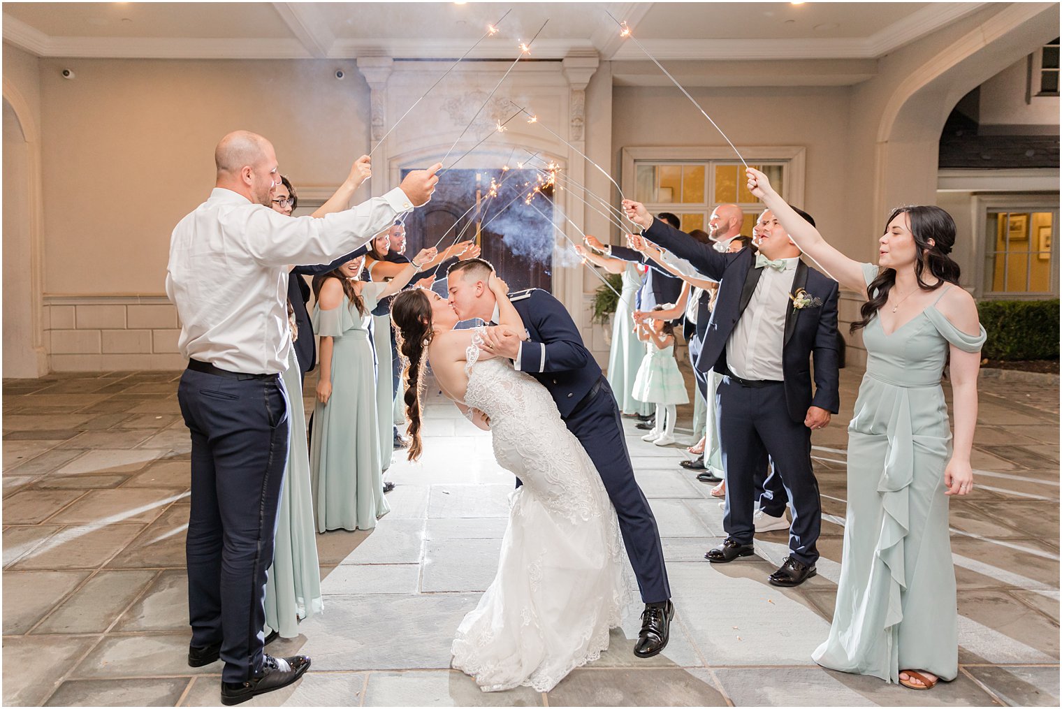 groom dips bride kissing her during sparkler exit at Park Chateau Estate