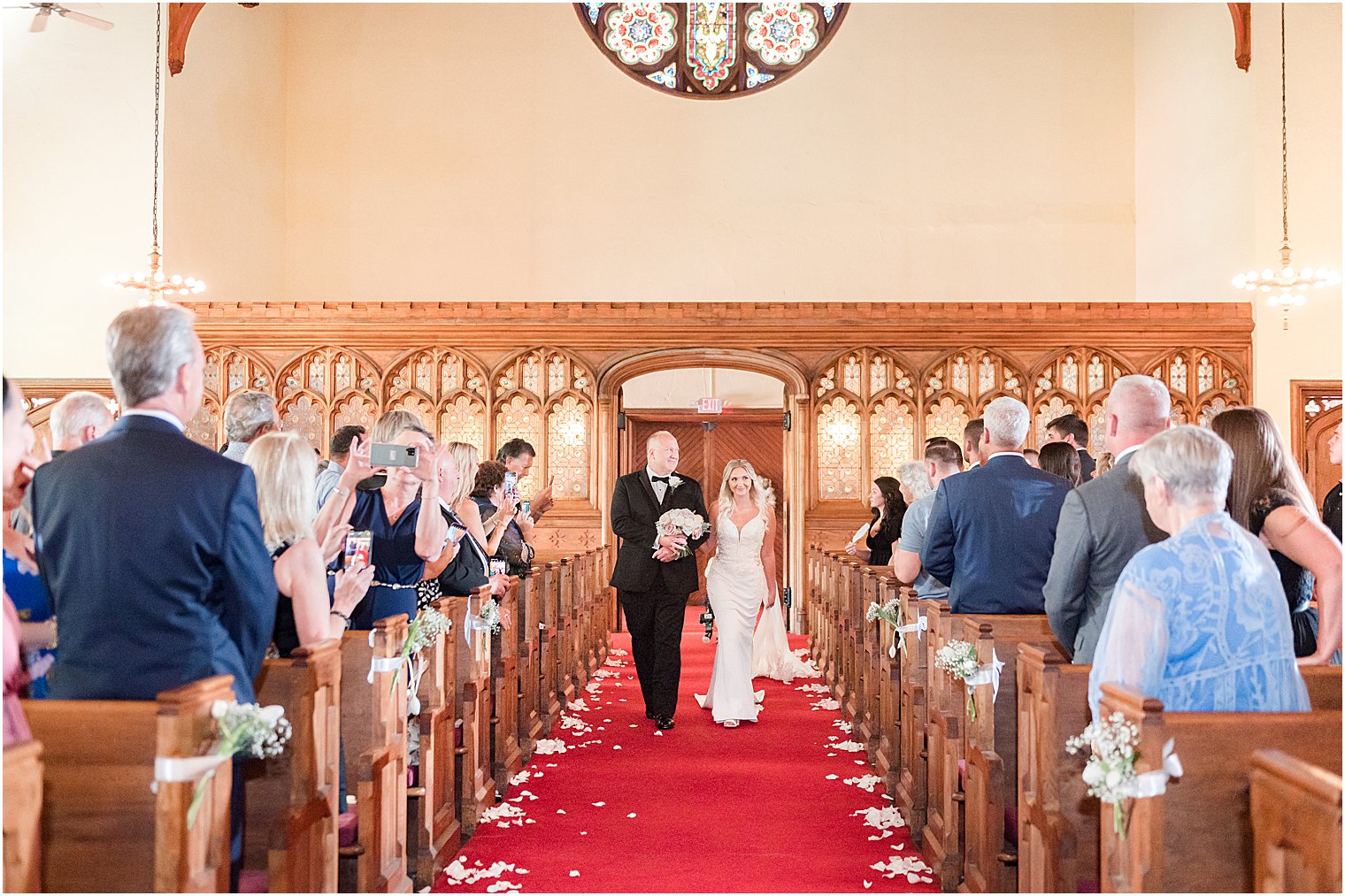 bride walks down aisle with father during traditional church wedding in New Jersey