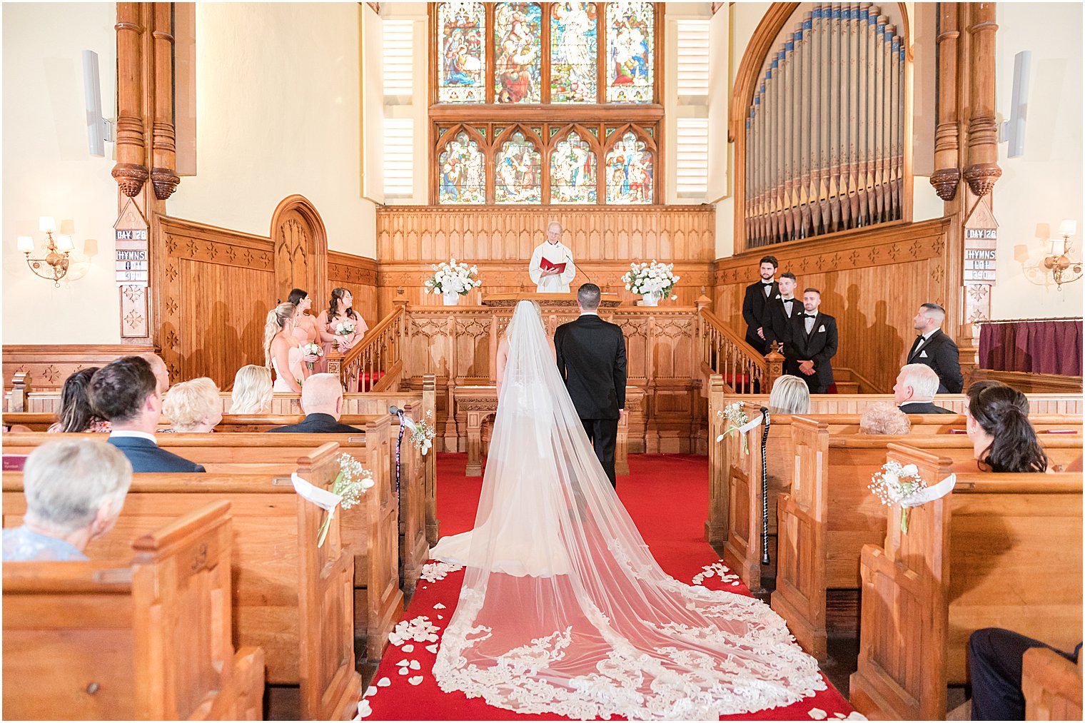 newlyweds stand at alter during traditional church wedding in New Jersey