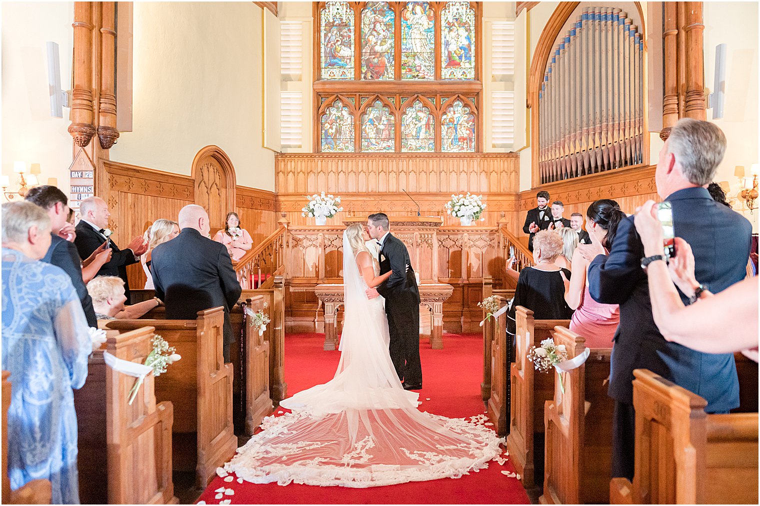 bride and groom kiss after traditional church wedding in New Jersey