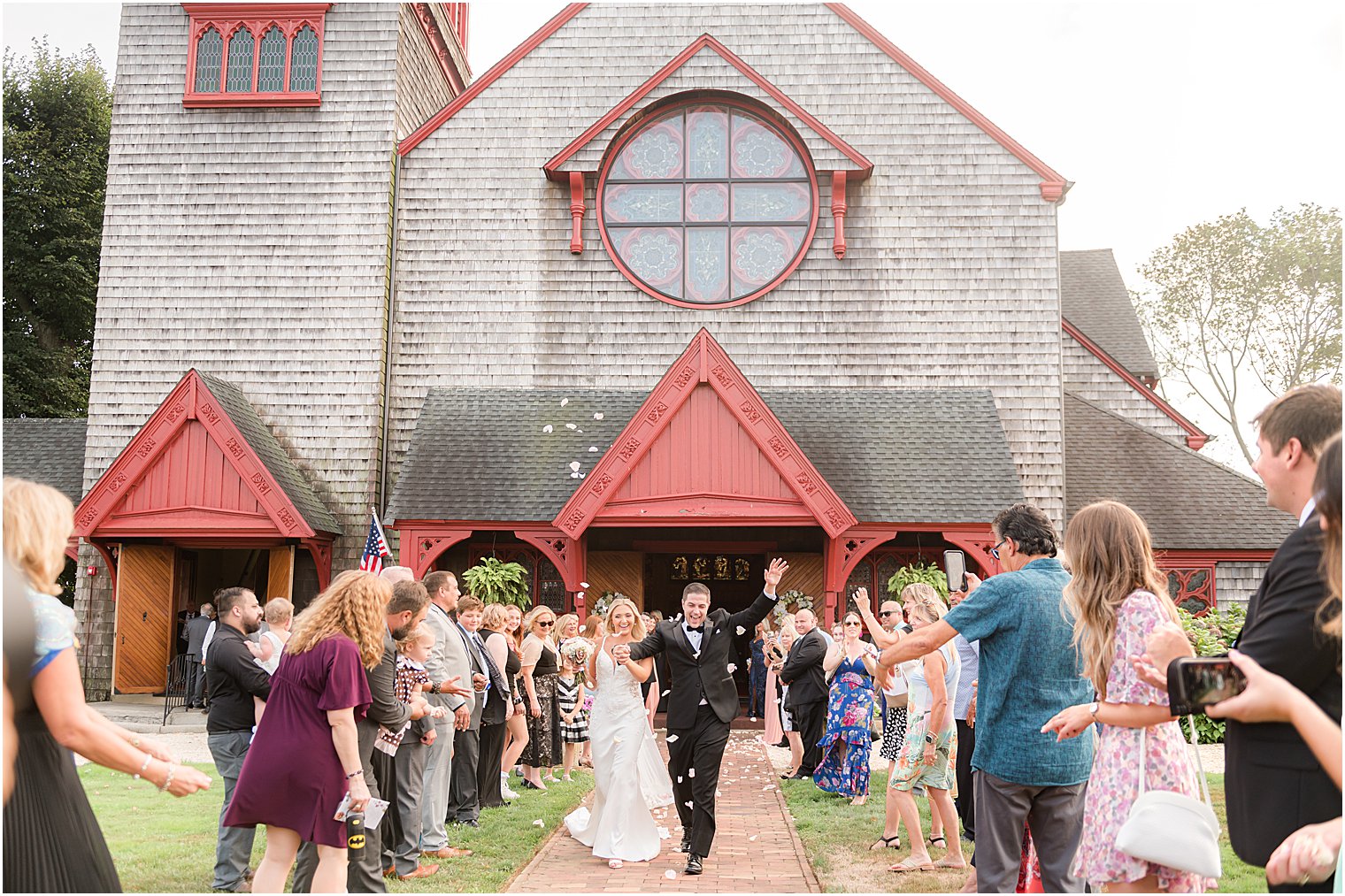 bride and groom leave traditional wooden church in Ocean NJ 