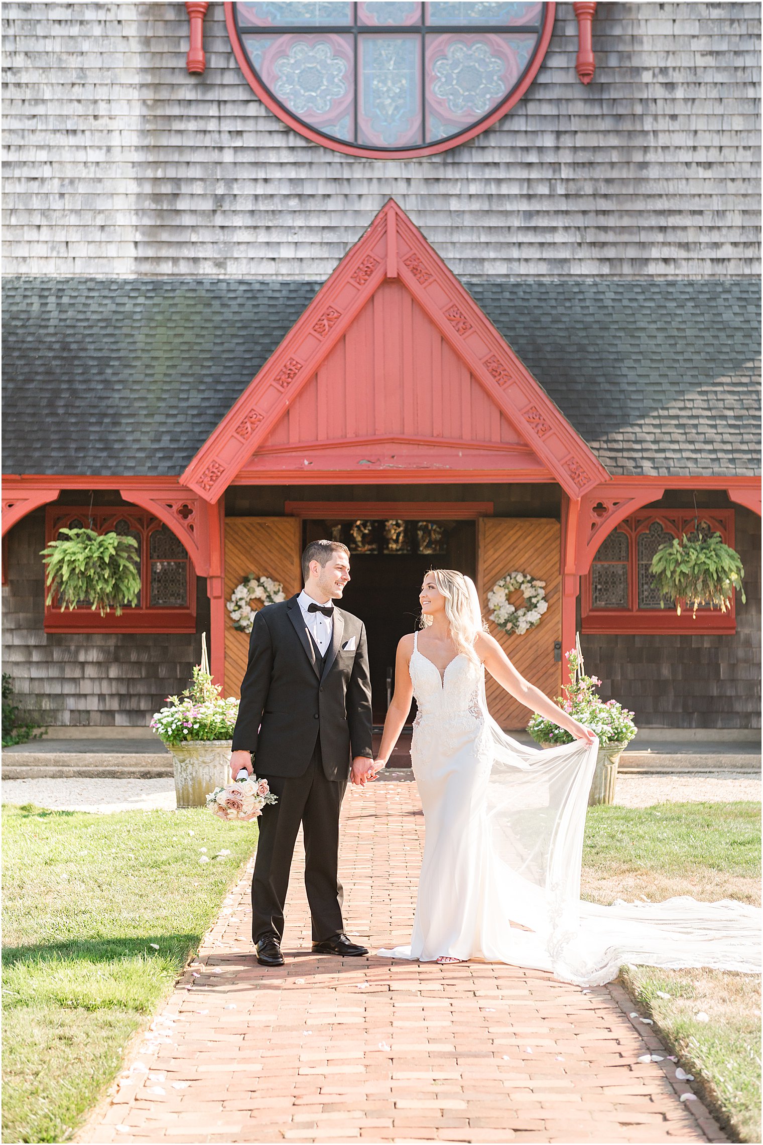 bride and groom hold hands outside wooden door of New Jersey church
