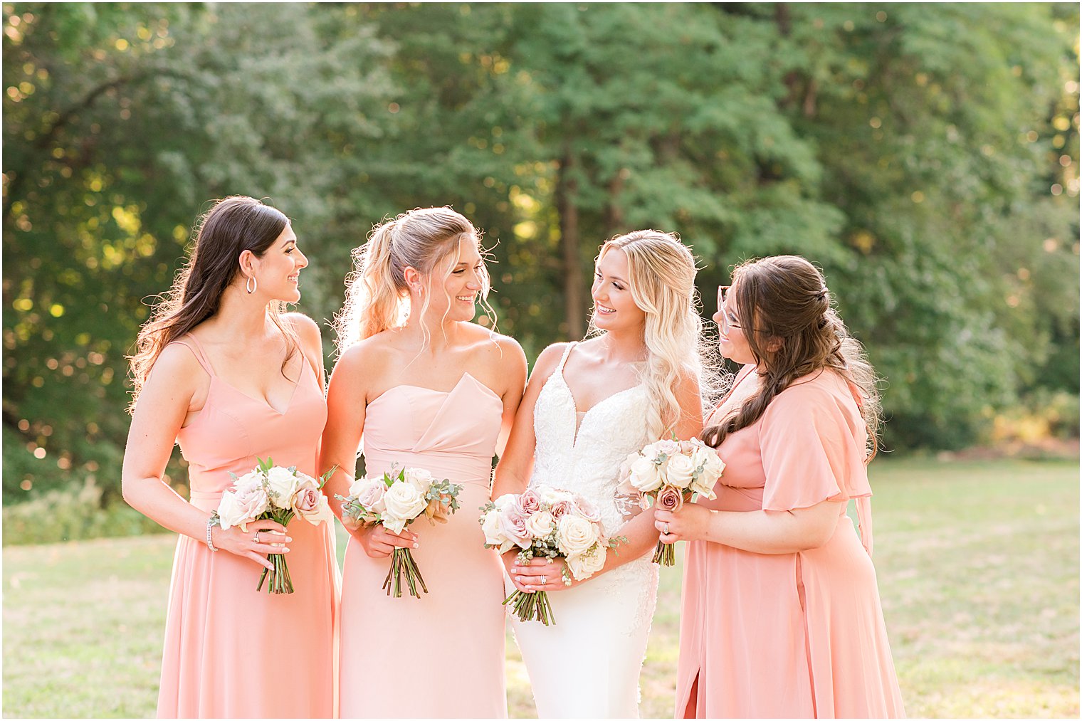 bride stands with bridesmaids in pink gowns at The English Manor