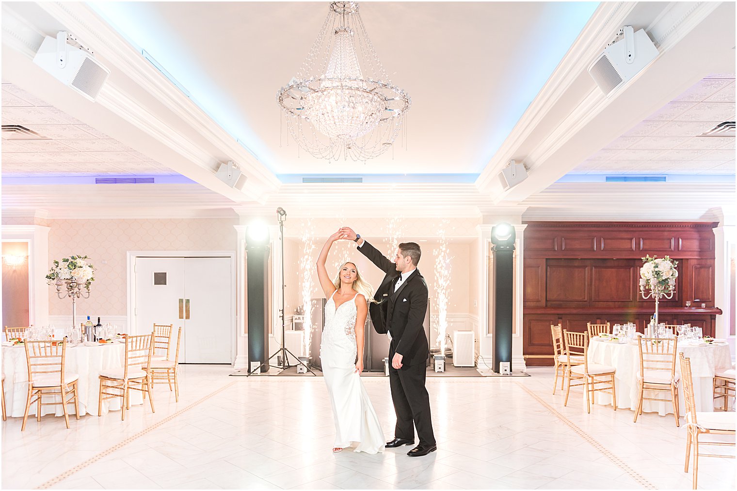 groom twirls bride in ballroom at The English Manor